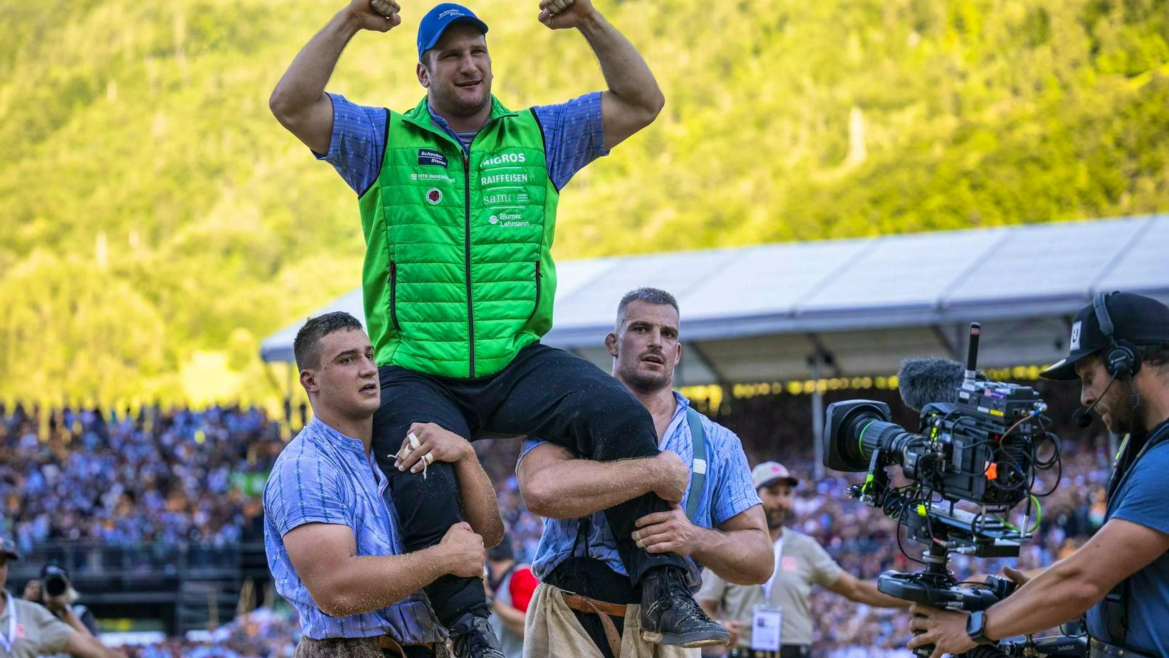 Armon Orlik celebrates on the shoulders of Samuel Giger, right, and Werner Schlegel.