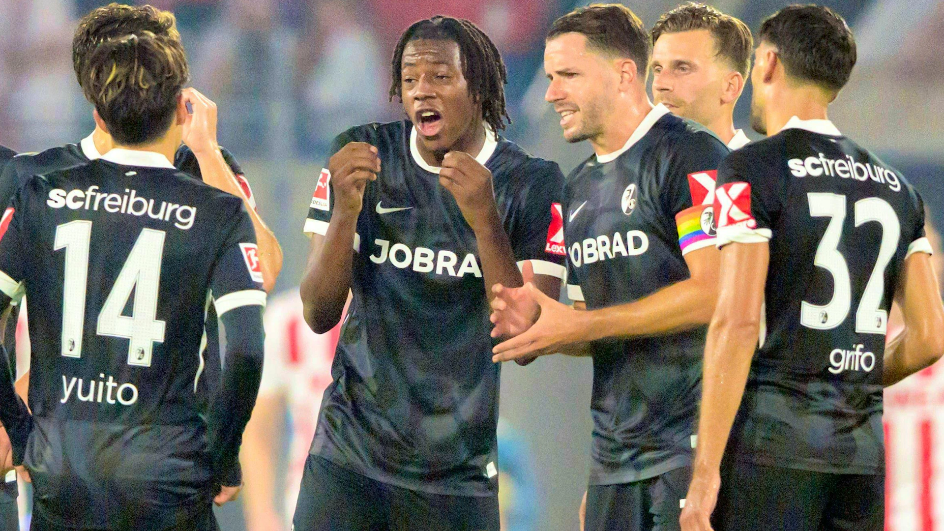 Christian Günter (with captain's armband) raves about national team youngster Johan Manzambi (left).