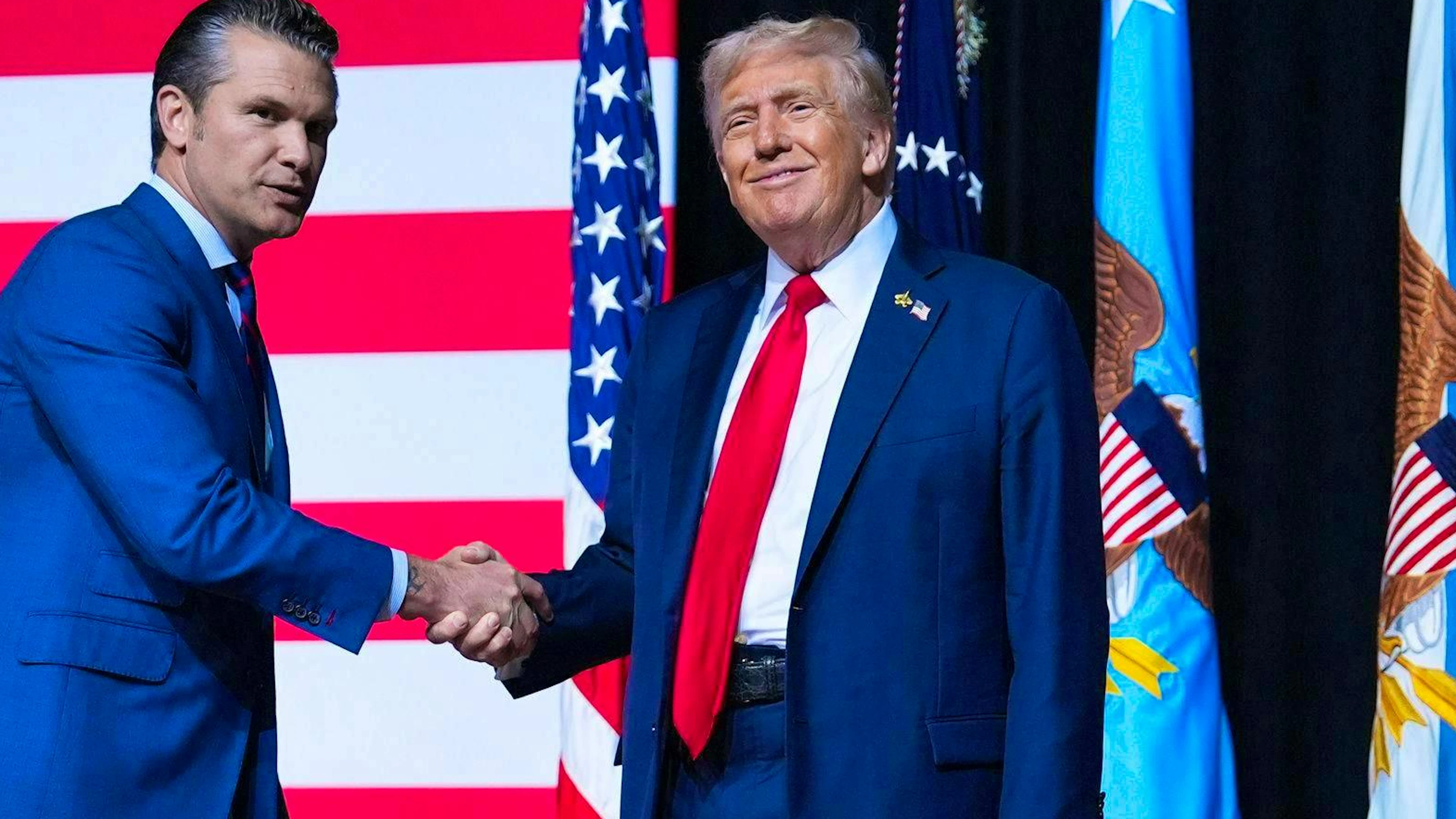 Mission accomplished: Pete Hegseth (left) and Donald Trump at Marine Corps Base Quantico on Sept. 30.