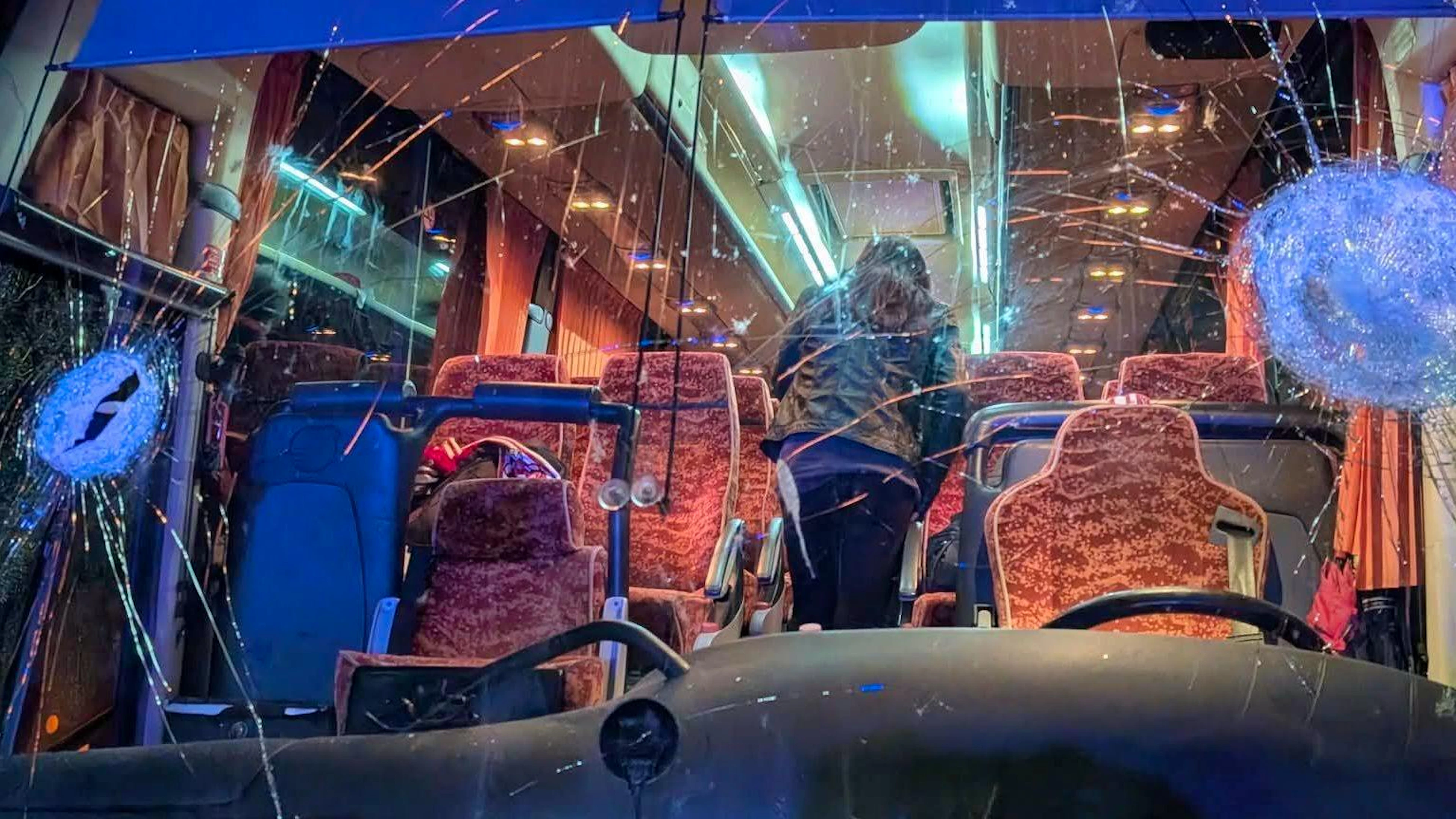 Il parabrezza del pullman preso a sassate e non solo.