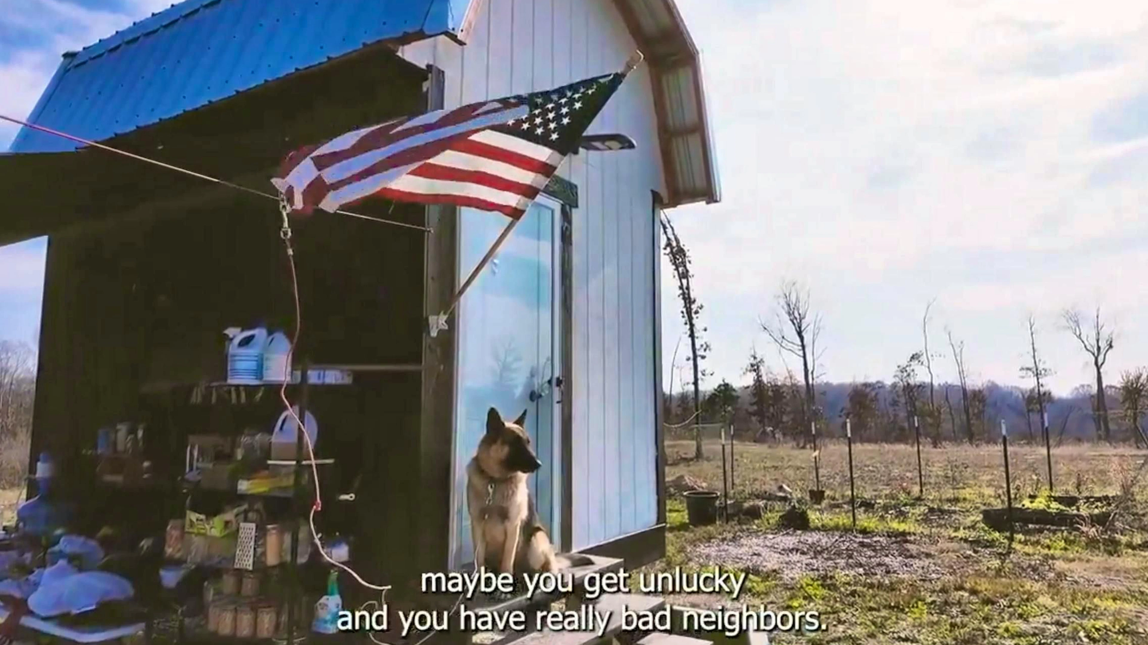 A US flag and a sheepdog protect against bad neighbors.
