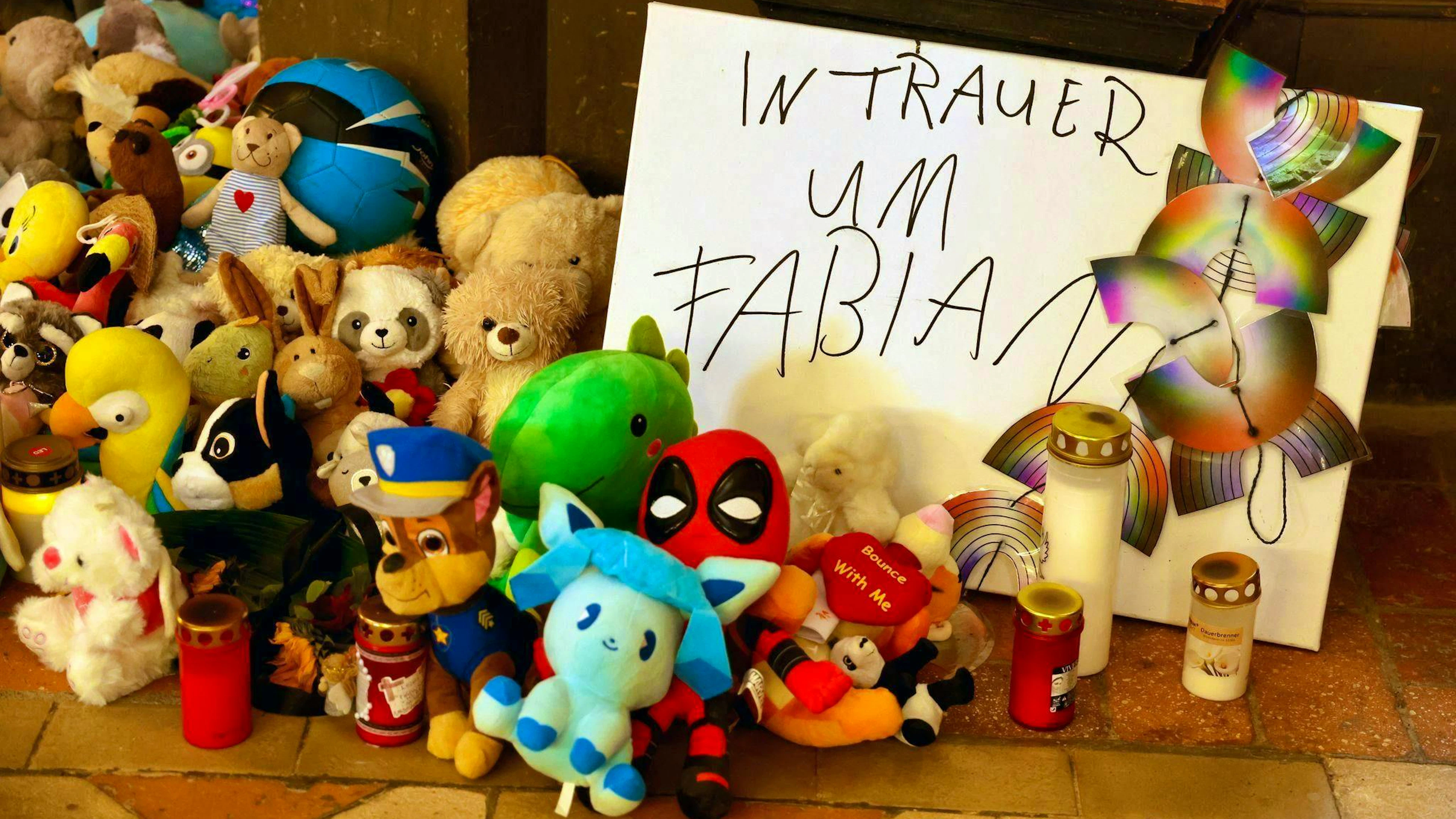 Cuddly toys and candles in memory of Fabian.