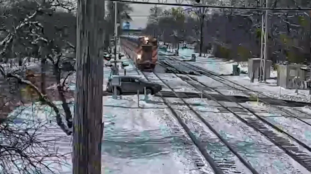 Train crashes into stationary car with full force