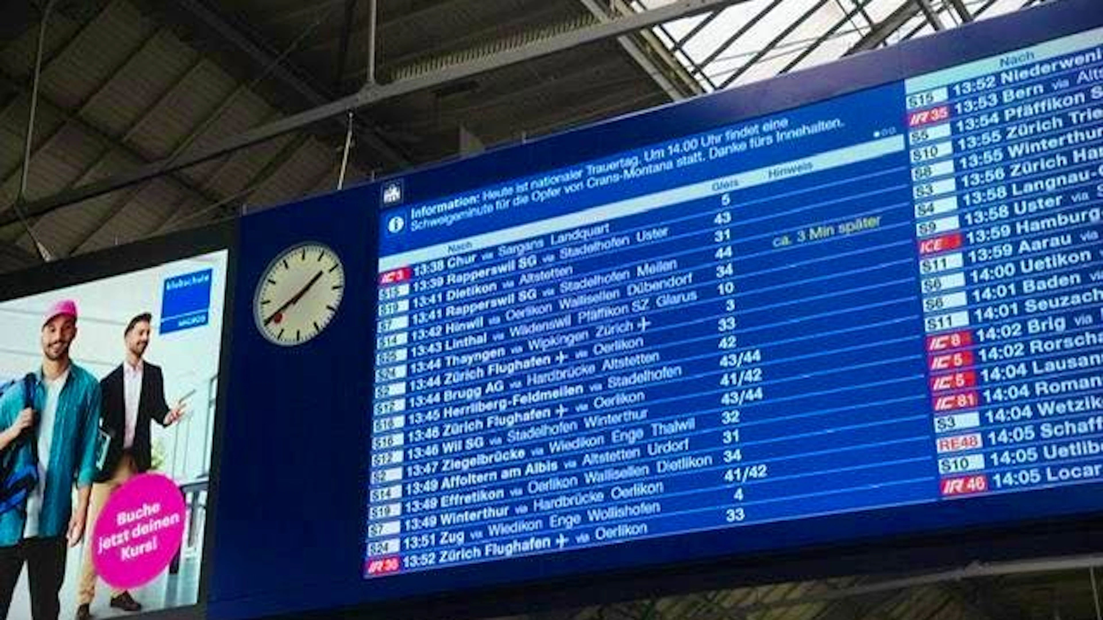 A minute's silence is announced on the main display board at Zurich main station.