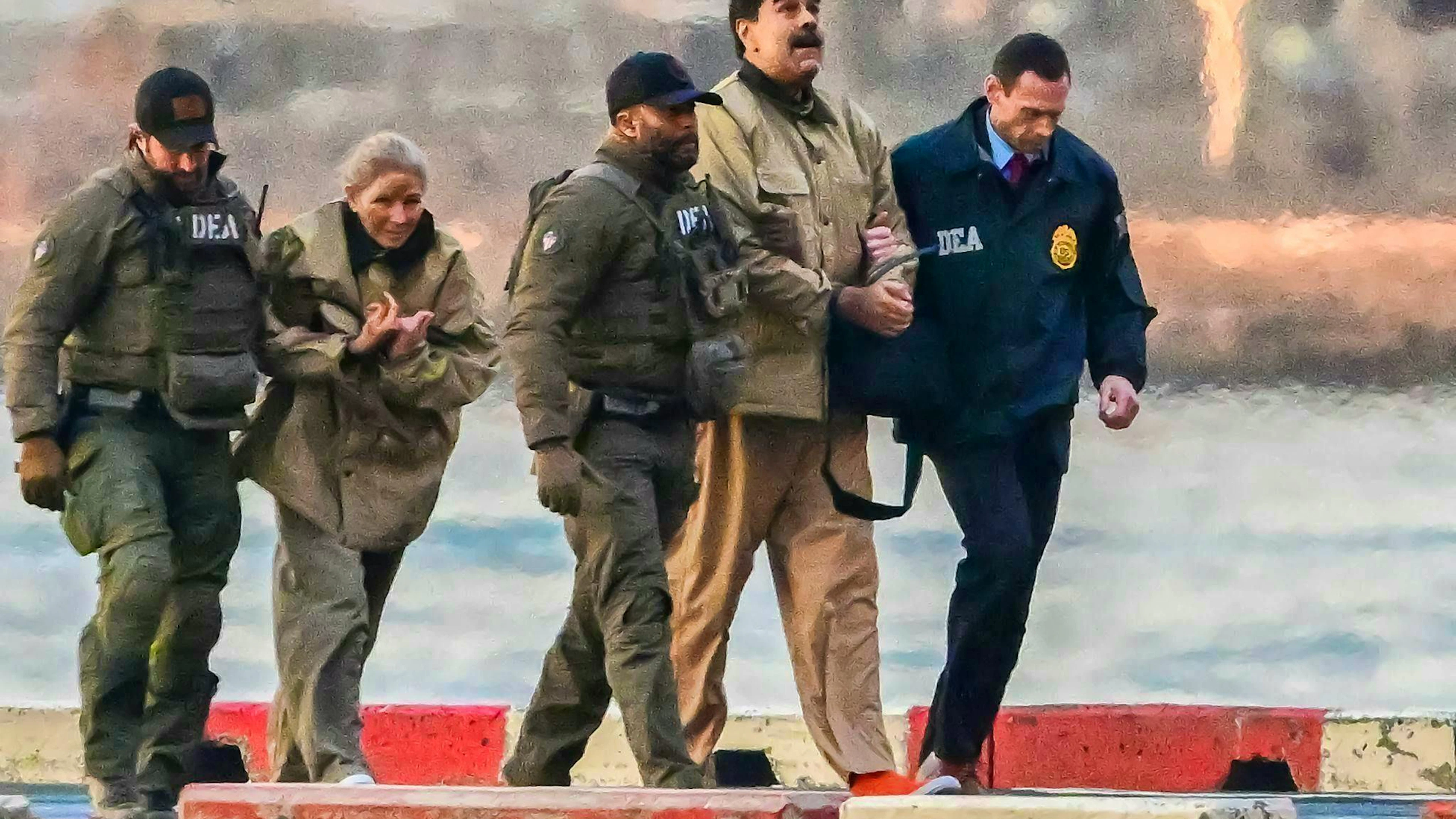 Surrounded by heavily armed security forces, captured Venezuelan President Nicolas Maduro (2nd from right) and his wife Cilia Flores (2nd from left) arrive at the Wall Street Heliport in the New York borough of Manhattan.