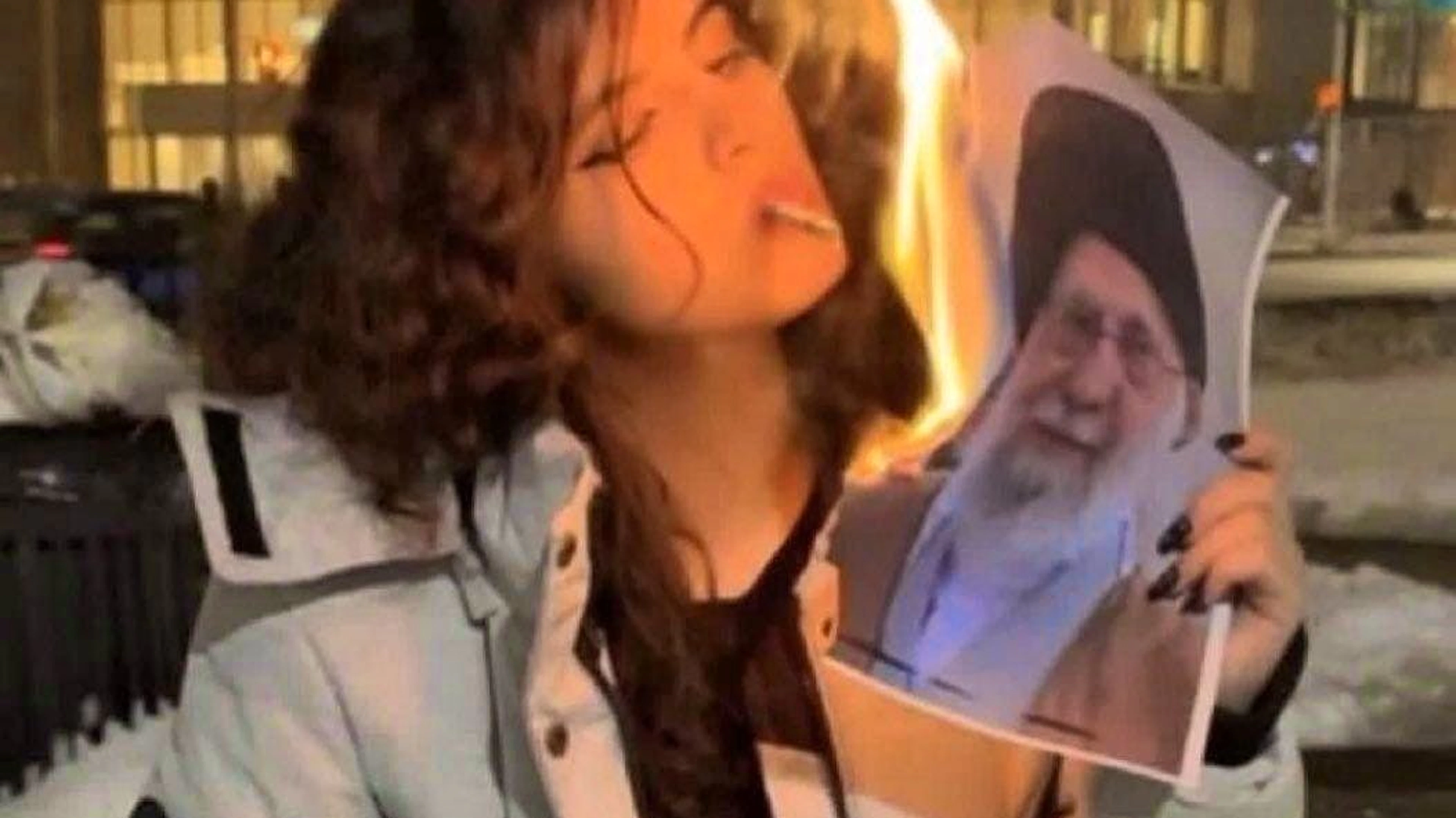 This woman went viral because she set fire to a photo of Iran's Supreme Leader, Ayatollah Ali Khamenei, in a video.
