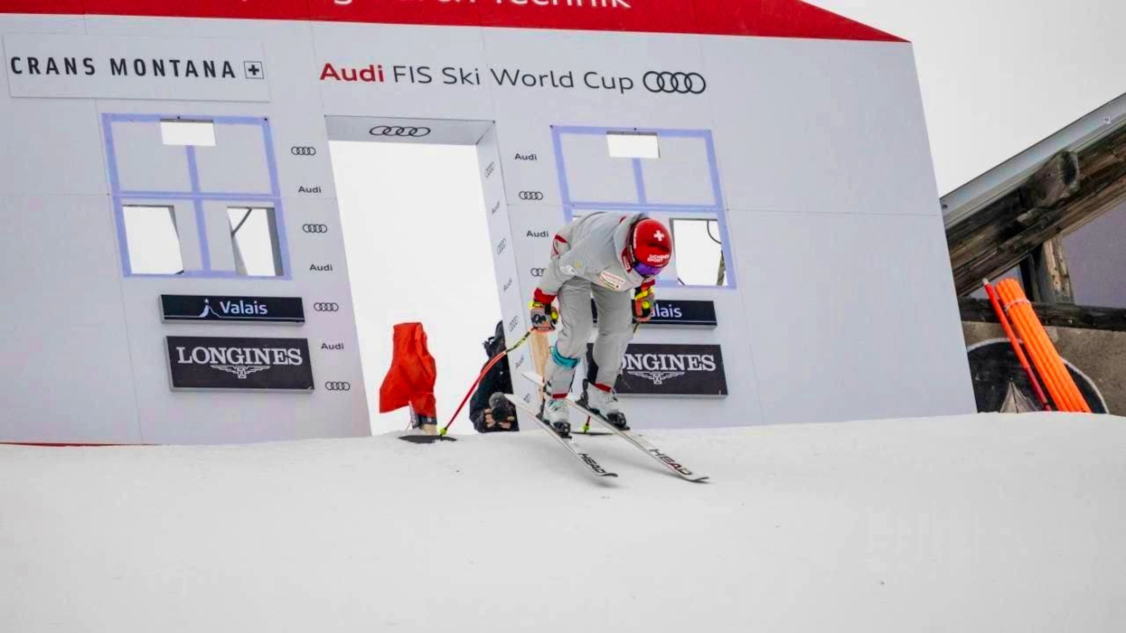 Corinne Suter pushes off from the start house while inspecting the downhill course.