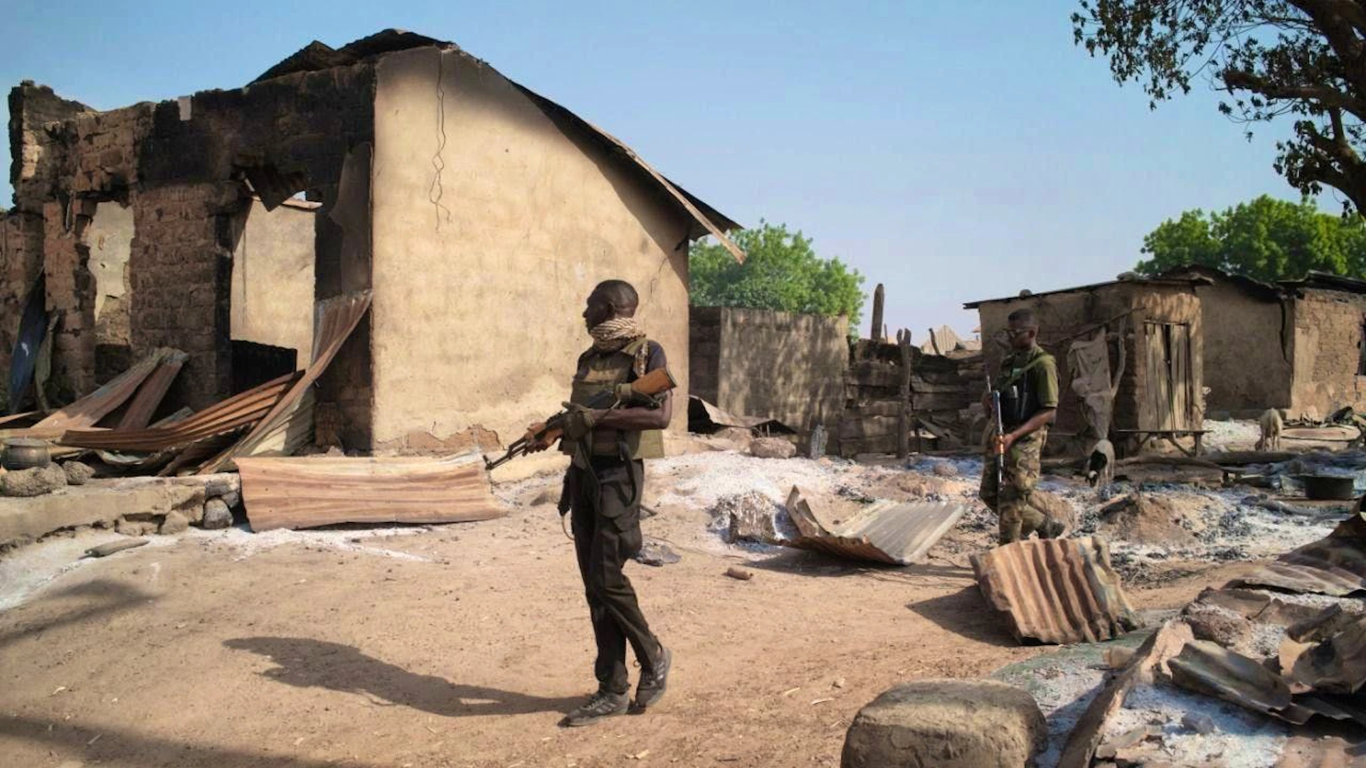 ARCHIVE - Soldiers patrol in front of burned houses, days after an attack in the village of Woro. Gunmen have killed dozens of people in an attack in Nigeria. Photo: Pelumi Salako/AP/dpa