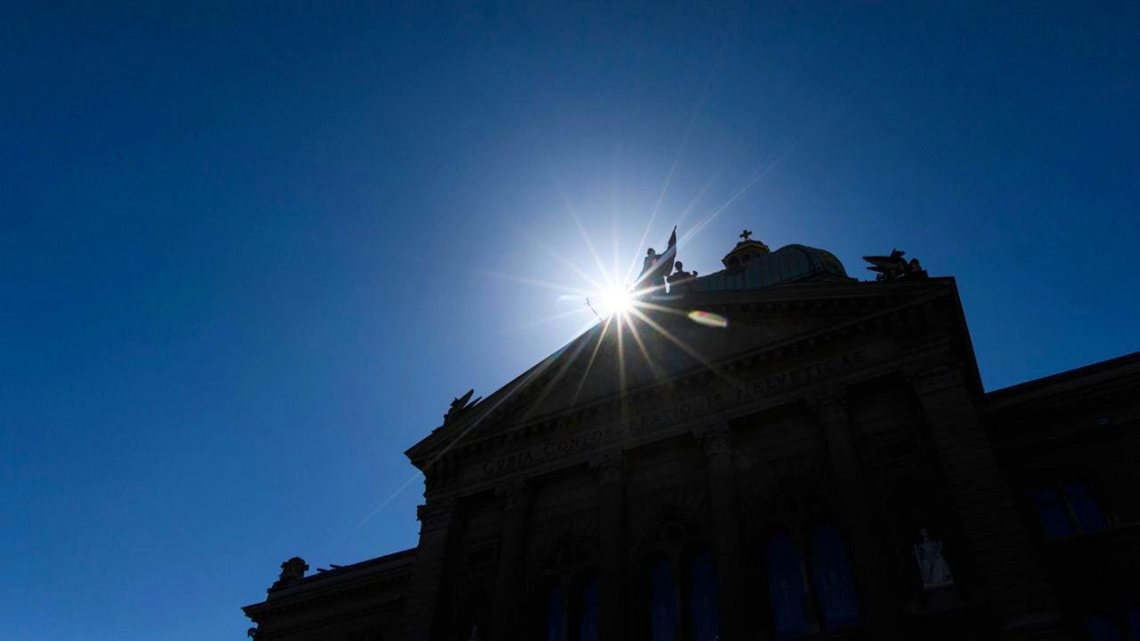 Il sole fa capolino dietro al Cupolone di Palazzo federale.