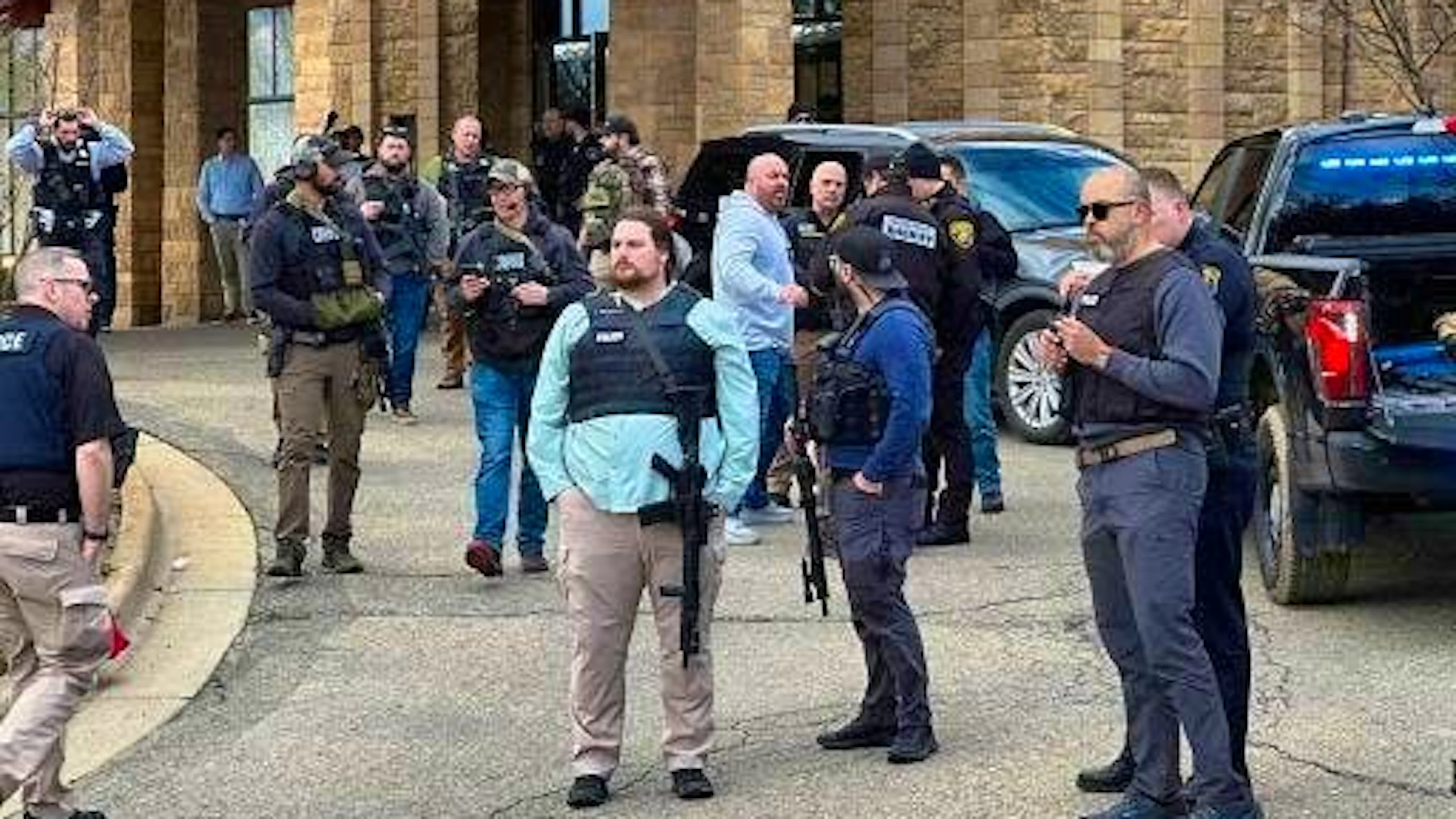 Police officers stand outside the synagogue in West Bloomfield.