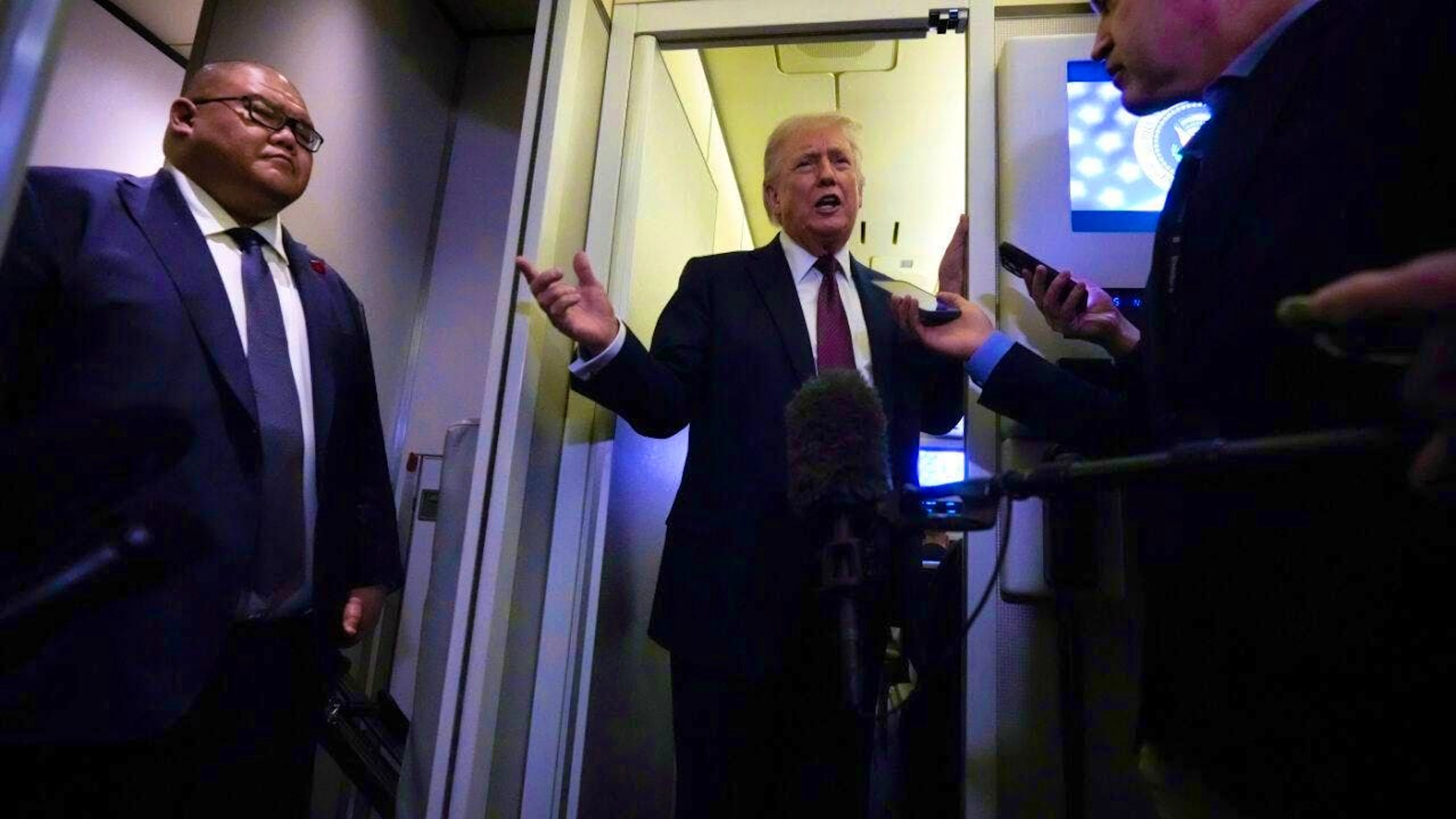 US President Donald Trump speaks to reporters on board Air Force One. Photo: Mark Schiefelbein/AP/dpa