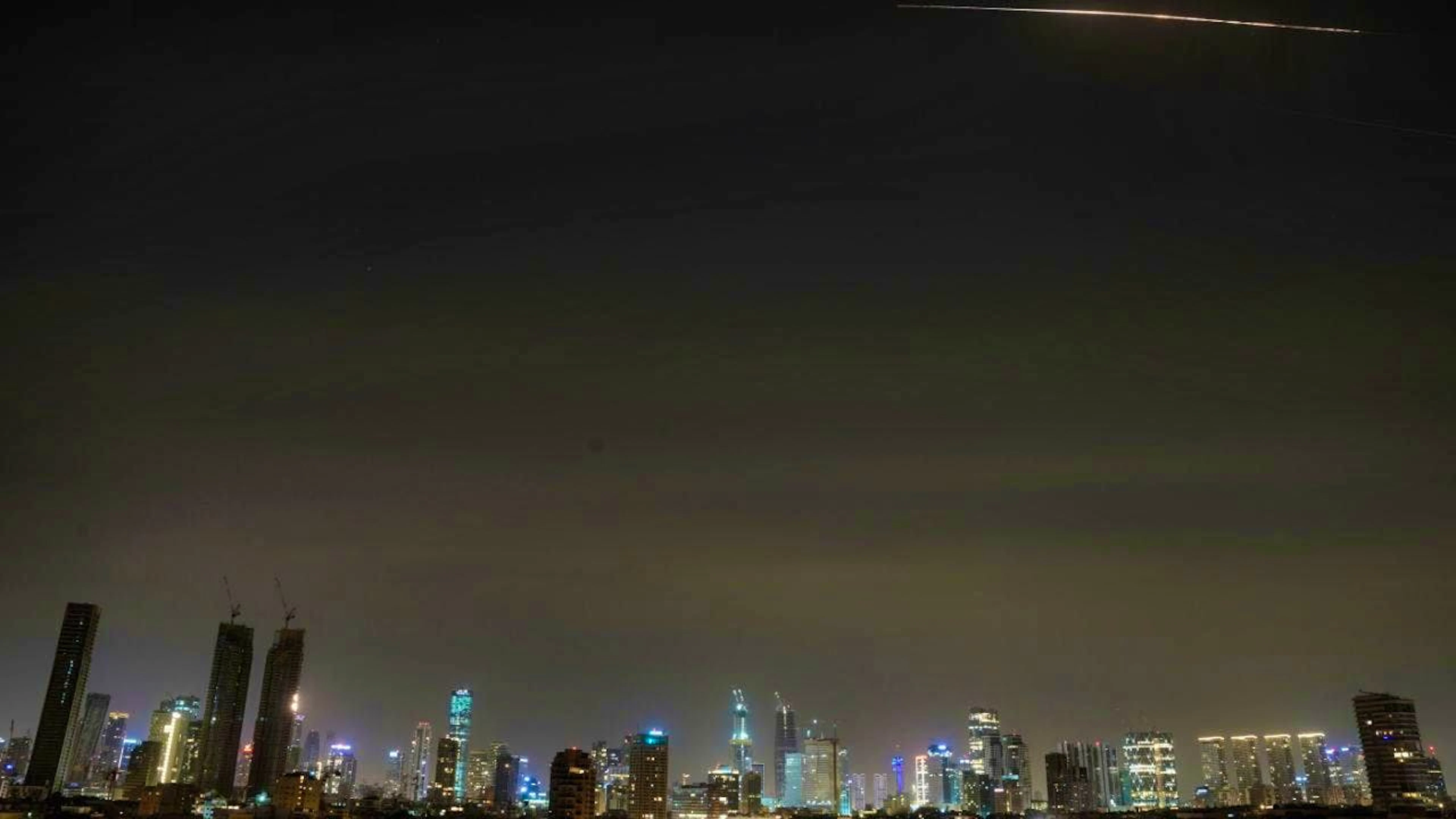 dpatopbilder - The remains of an Iranian missile are seen in the sky over Tel Aviv after it was intercepted on Saturday morning. Photo: Maya Levin/AP/dpa