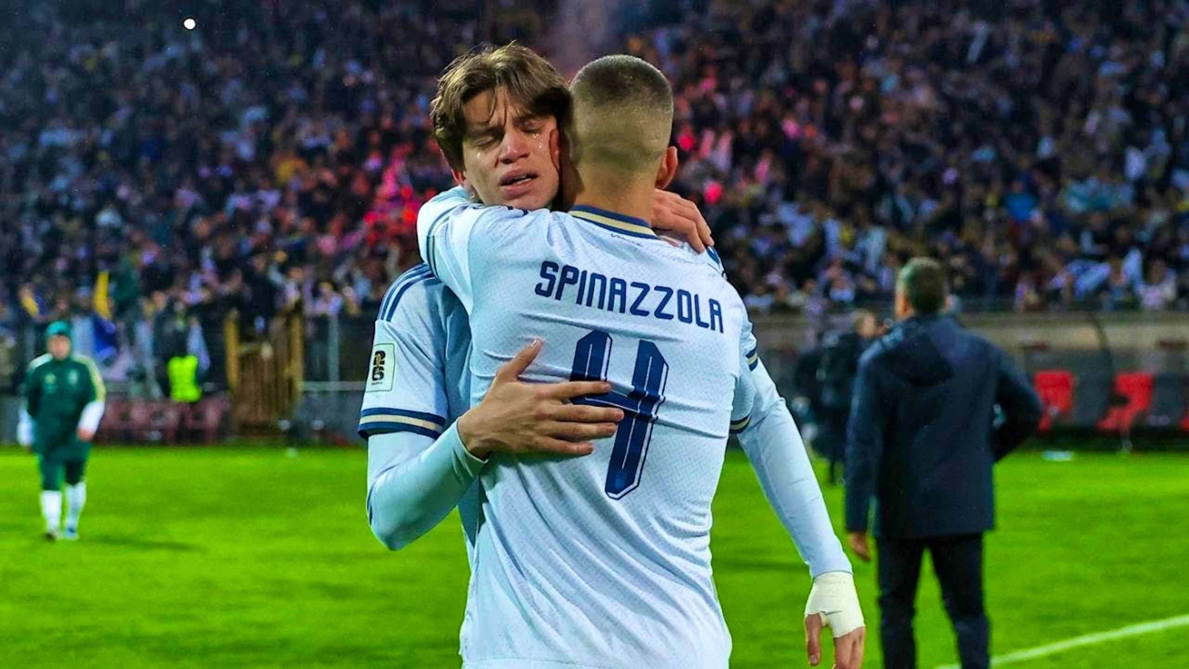 Marco Palestra and Leonardo Spinazzola comfort each other after Italy's defeat in the penalty shoot-out against Bosnia