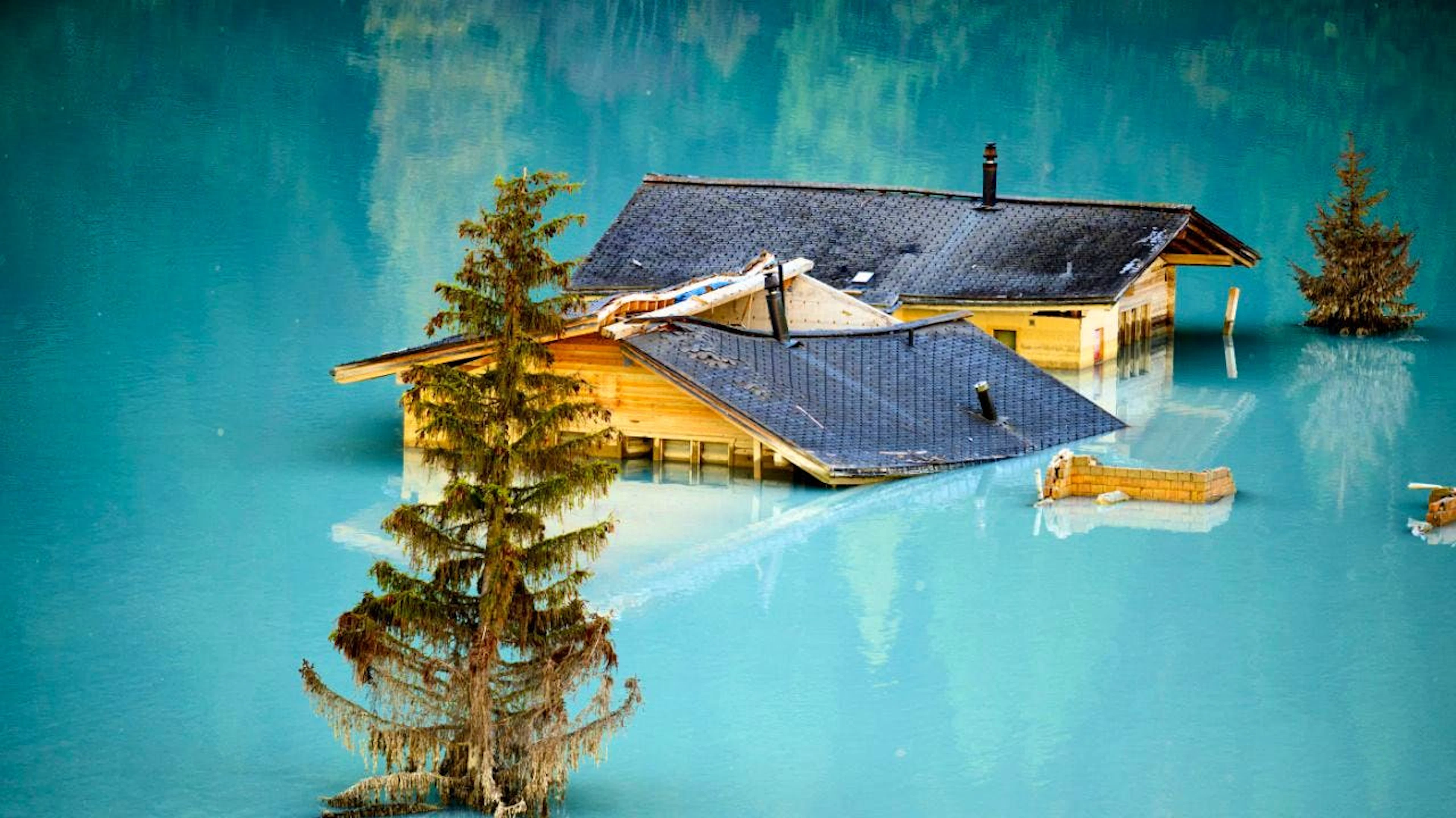 Le due case sommerse emergono come isole dopo la drammatica frana.