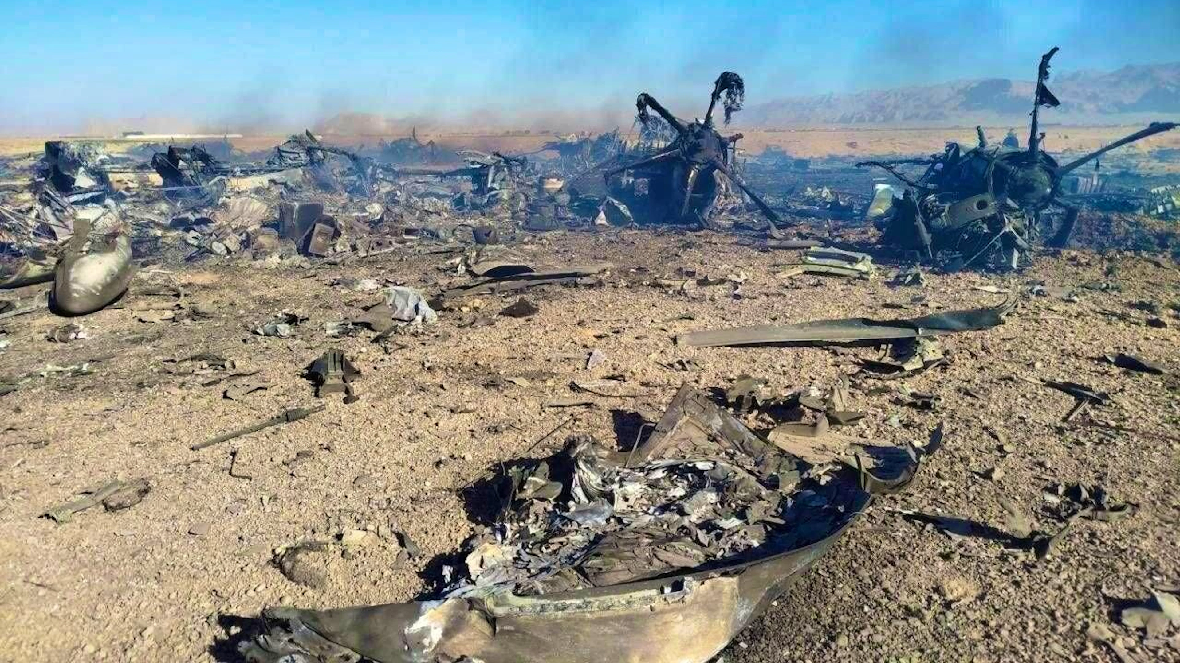 Iranian state media published images of charred debris from several US aircraft in a desert area.