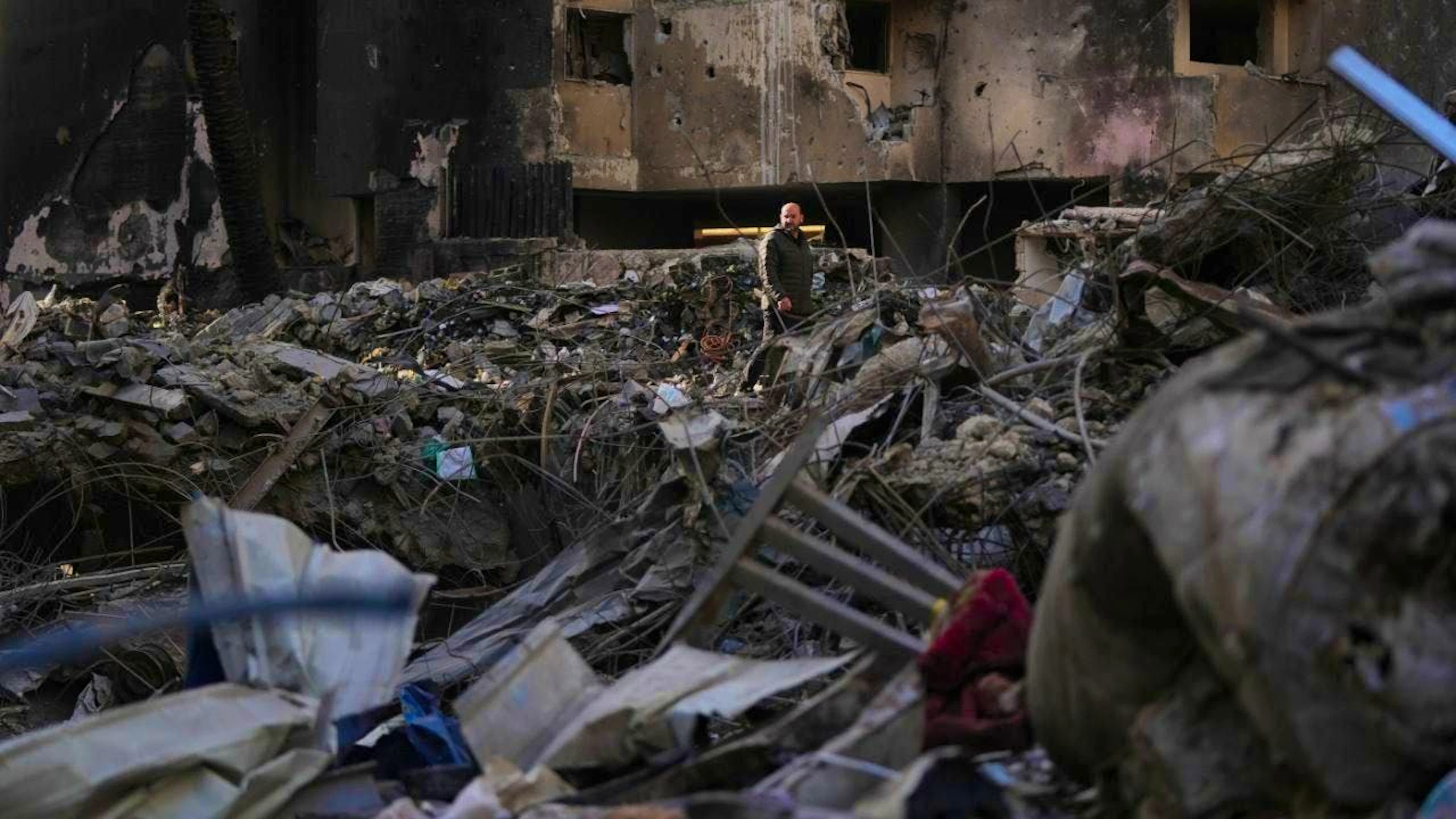 A resident walks in the rubble of a building destroyed by an Israeli airstrike in the center of Beirut last Wednesday. Photo: Hassan Ammar/AP/dpa