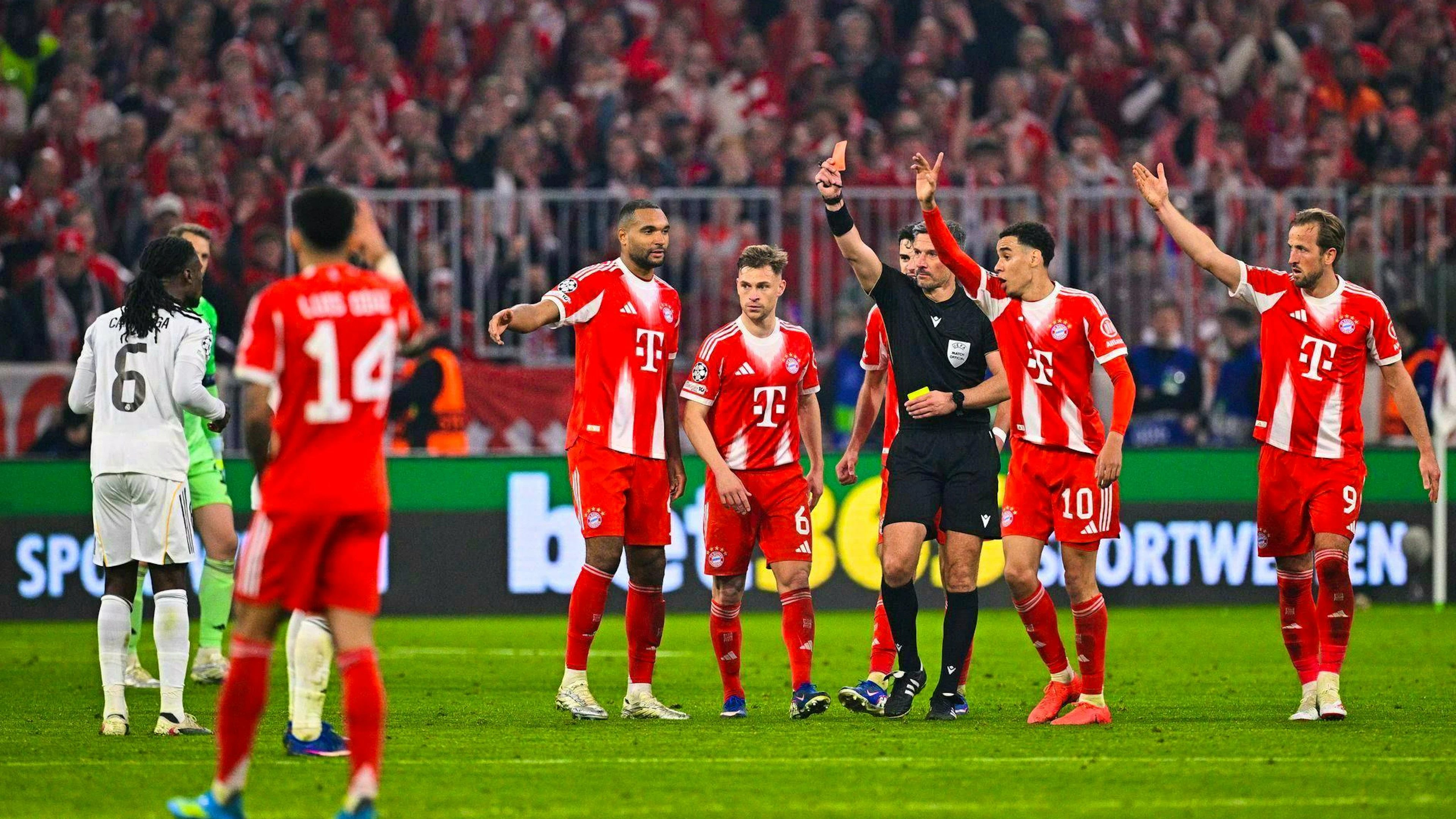 The key scene: Referee Slavko Vinčić shows Real's Eduardo Camavinga (l) a yellow card.