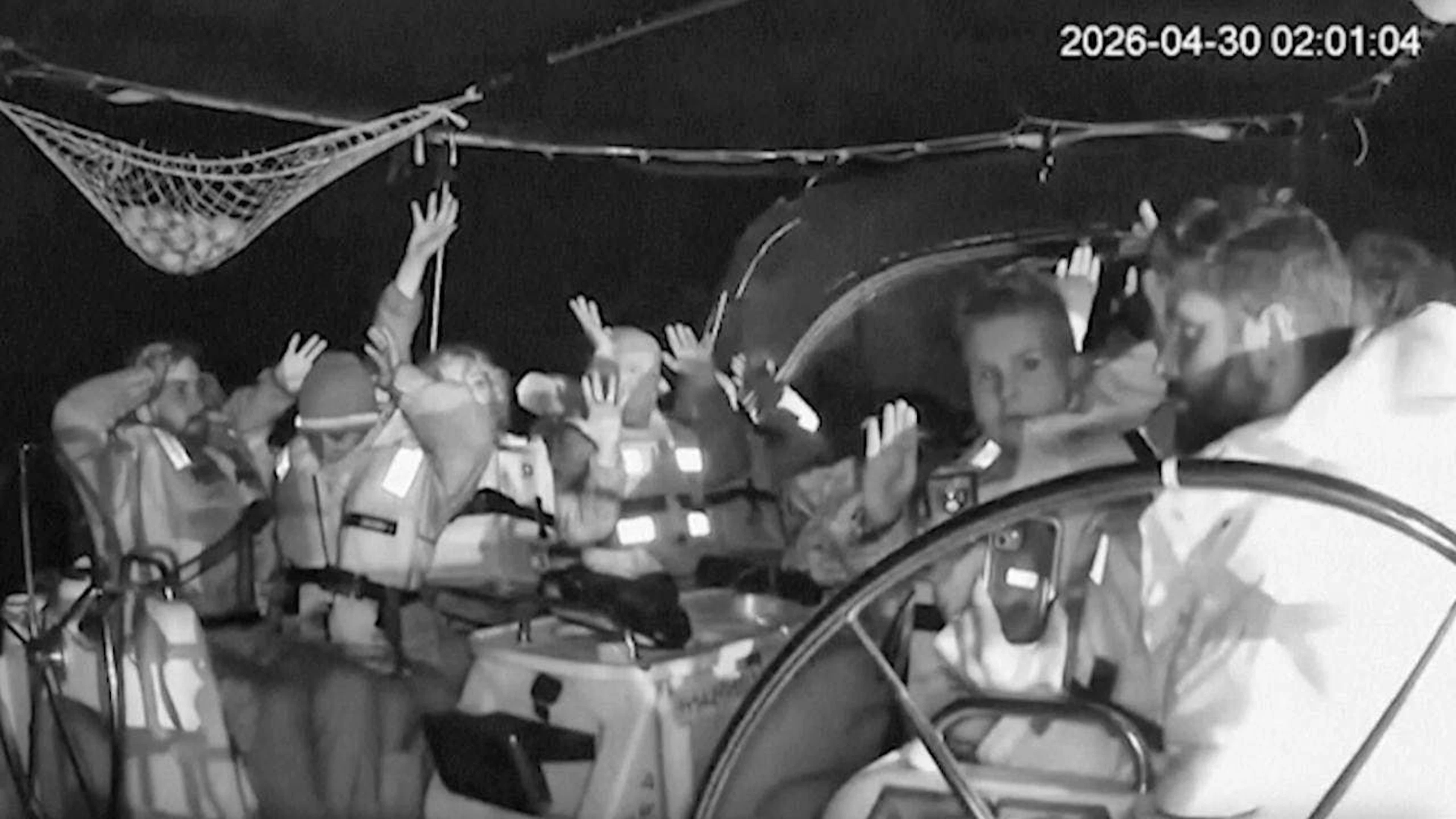 HANDOUT - This image released by the Global Sumud Flotilla via AP from a surveillance camera shows members of the Gaza aid flotilla with their hands in the air as Israeli forces intercept the activists' boats, which set sail from Barcelona earlier this month to break Israel's naval blockade of the Gaza Strip, near the Greek island of Crete early Thursday. Photo: Uncredited/Global Sumud Flotilla/AP/dpa