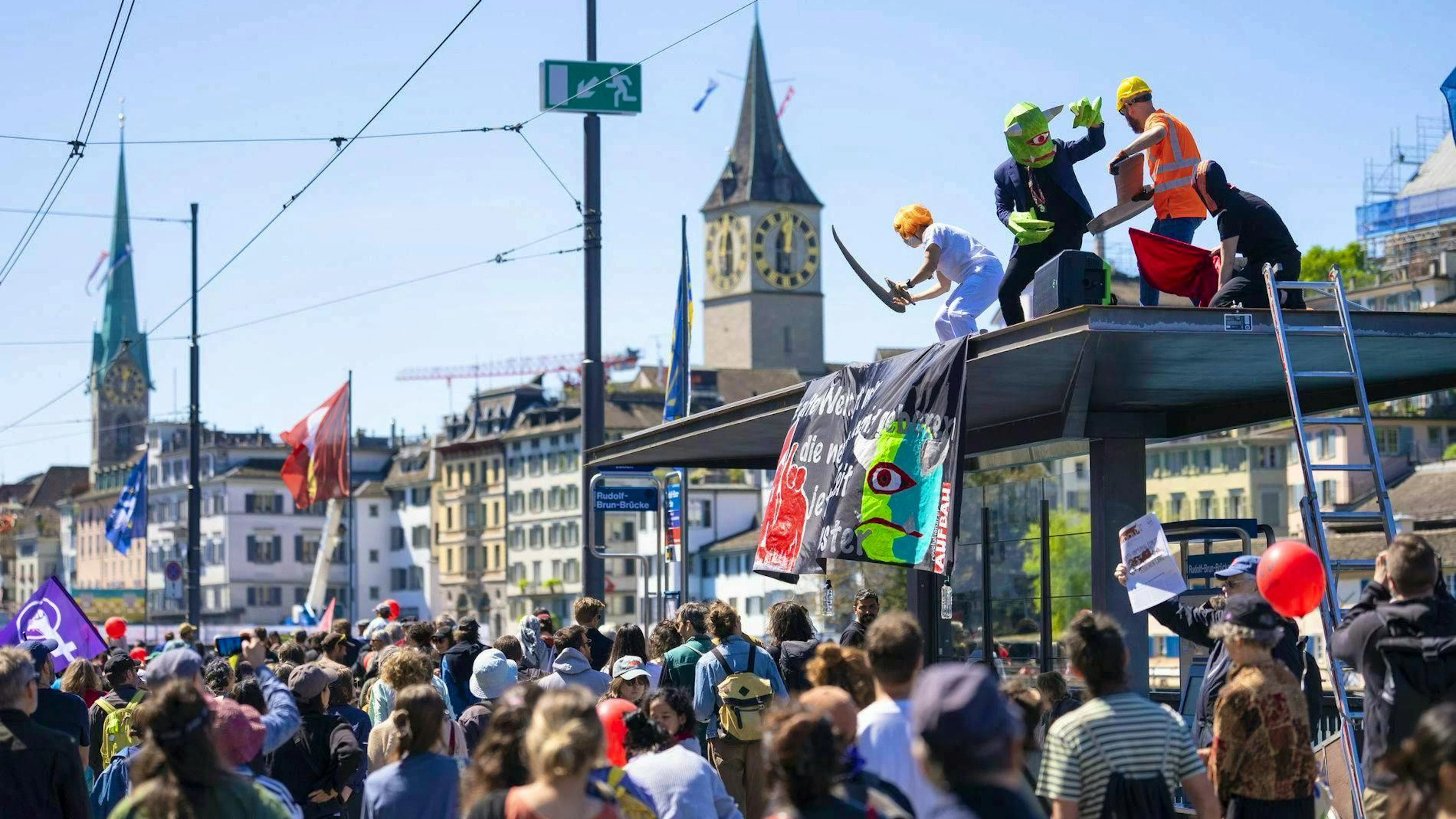 Participants demonstrate at the traditional May Day procession. Some climbed onto the roof of a streetcar stop.