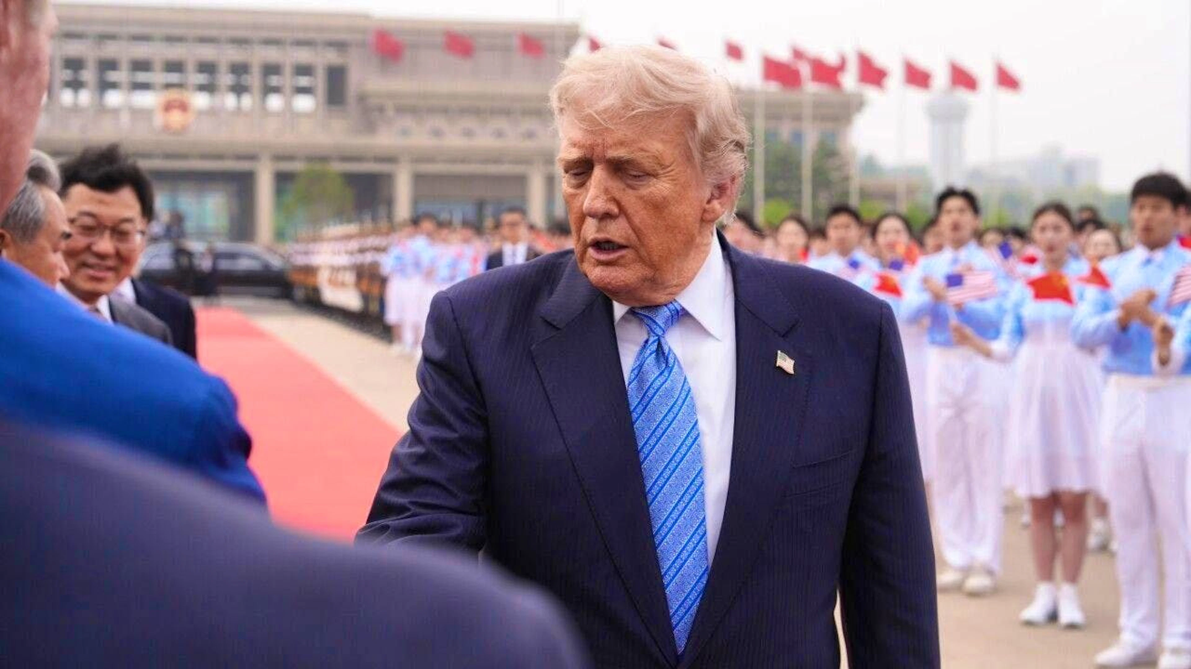 US President Donald Trump is greeted by officials before boarding Air Force One at Beijing Capital International Airport. Photo: Mark Schiefelbein/AP/dpa