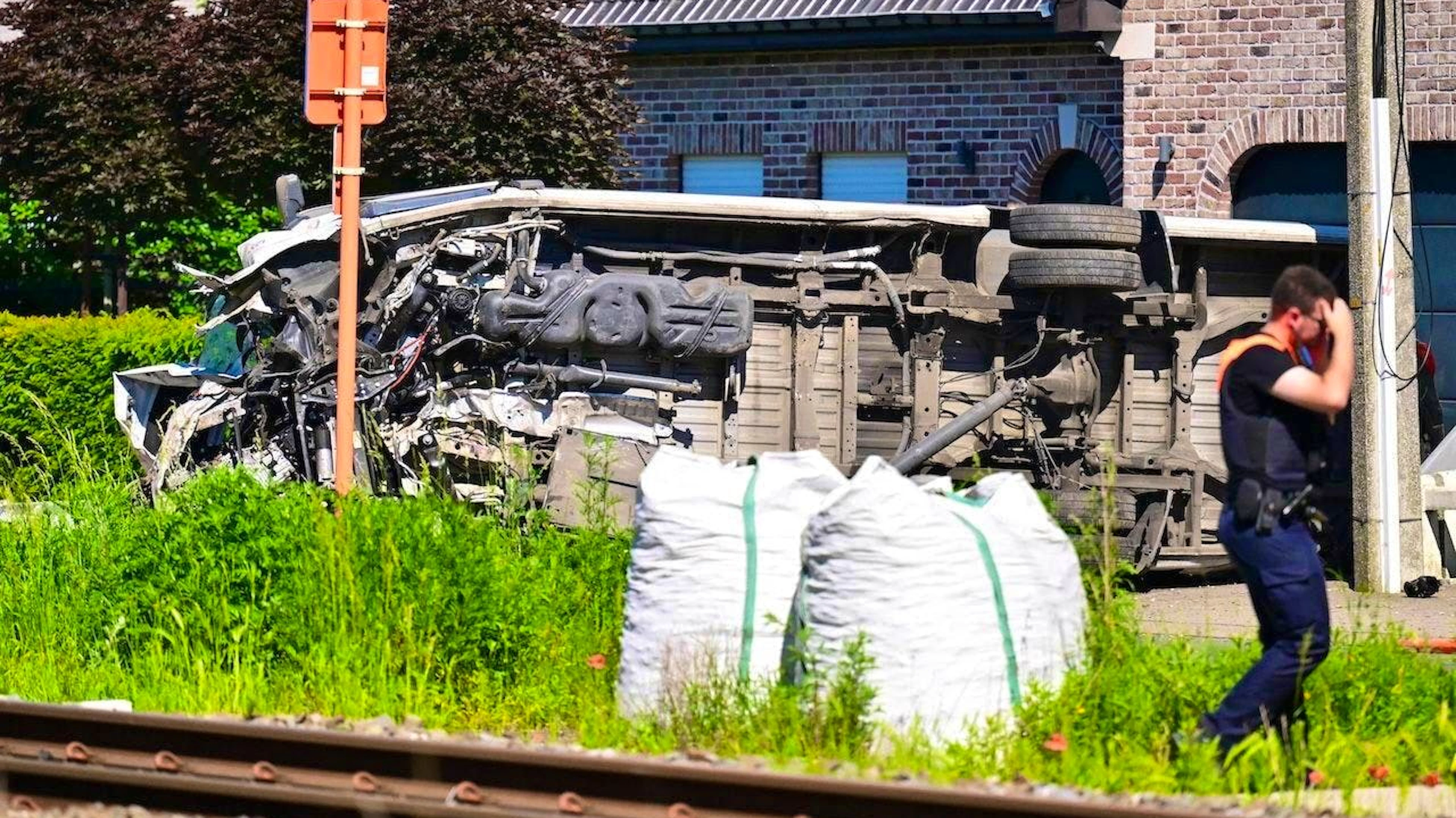 The school bus lies on its side in Buggenhout.