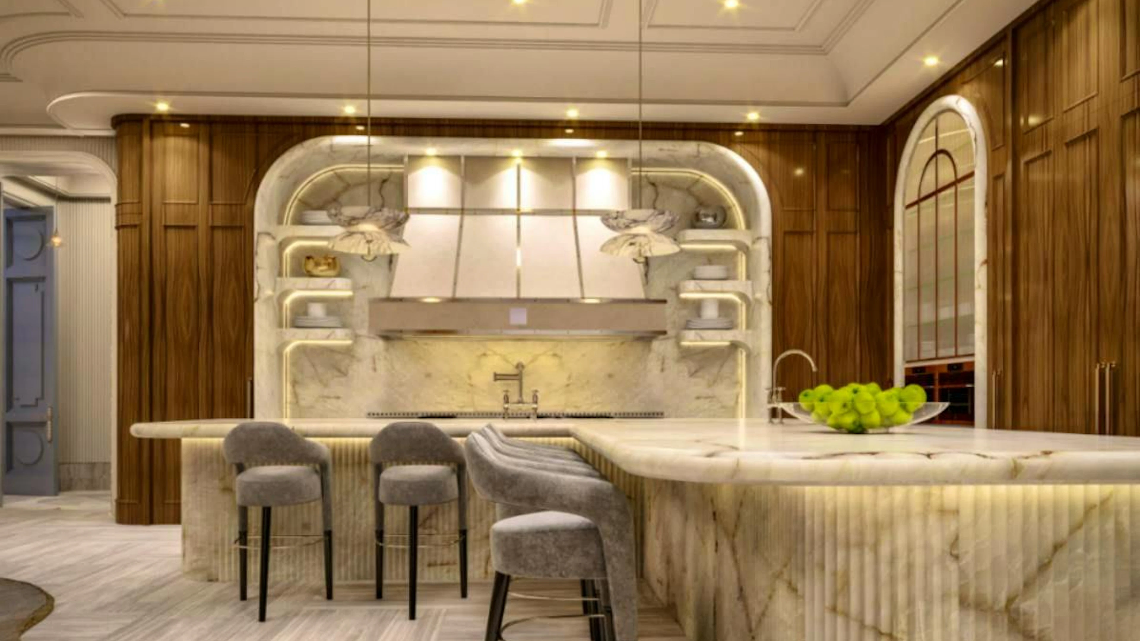 La cucina con un'isola di marmo a forma di L con dettagli scanalati.