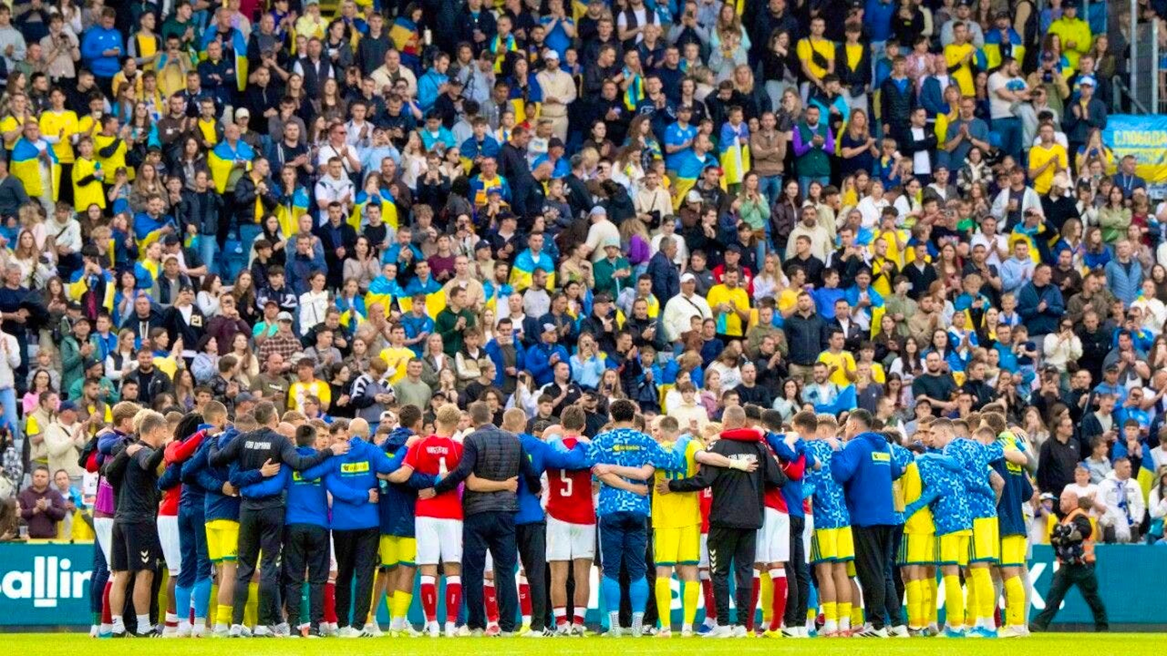 The Danish and Ukrainian players and coaches form a circle after Christian Eriksen's collapse - the all-clear is later given by the medical team