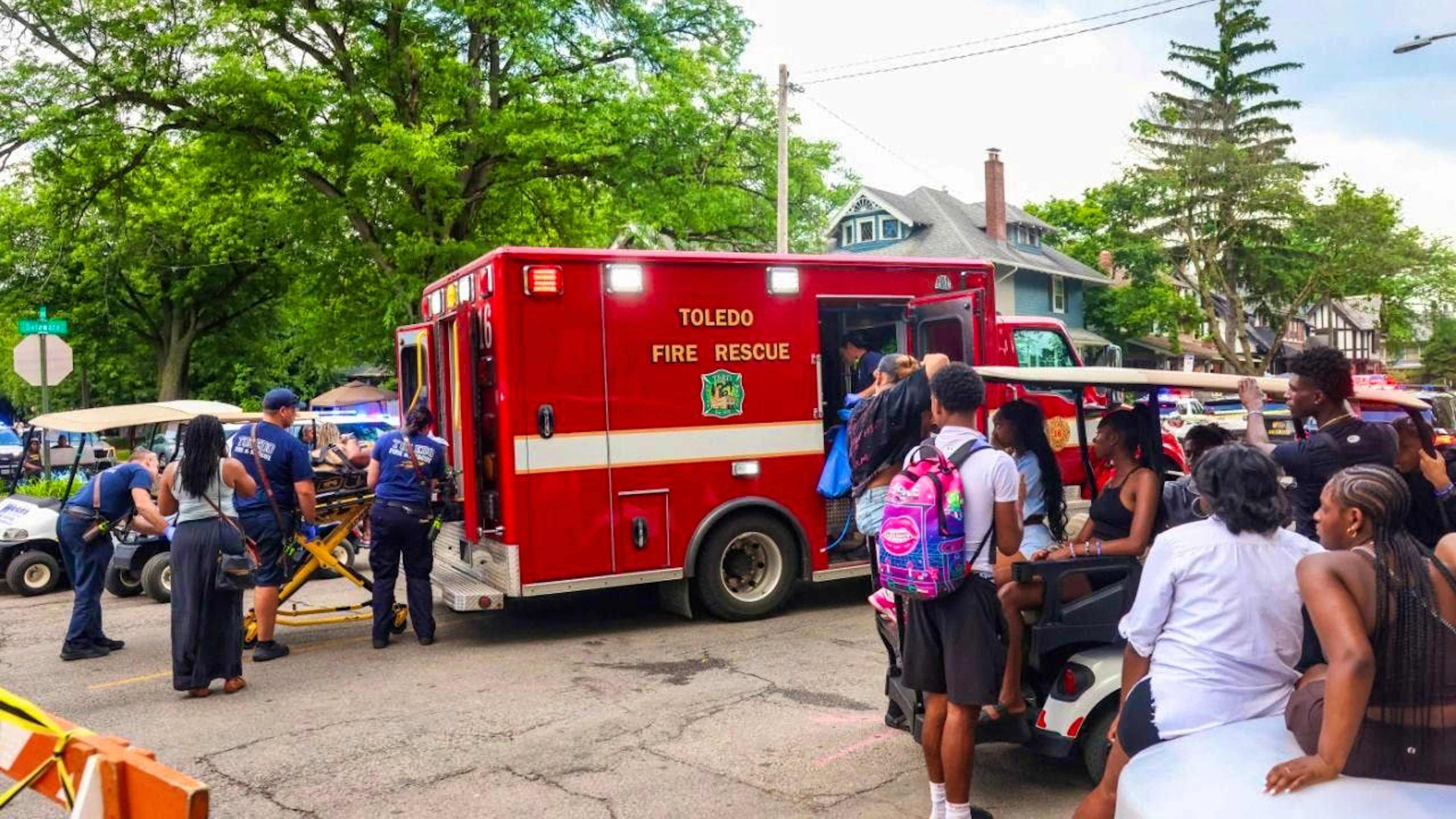 Toledo rescue workers transport an injured person away. Twelve people have been injured in a shooting incident at a summer festival in Toledo, Ohio.