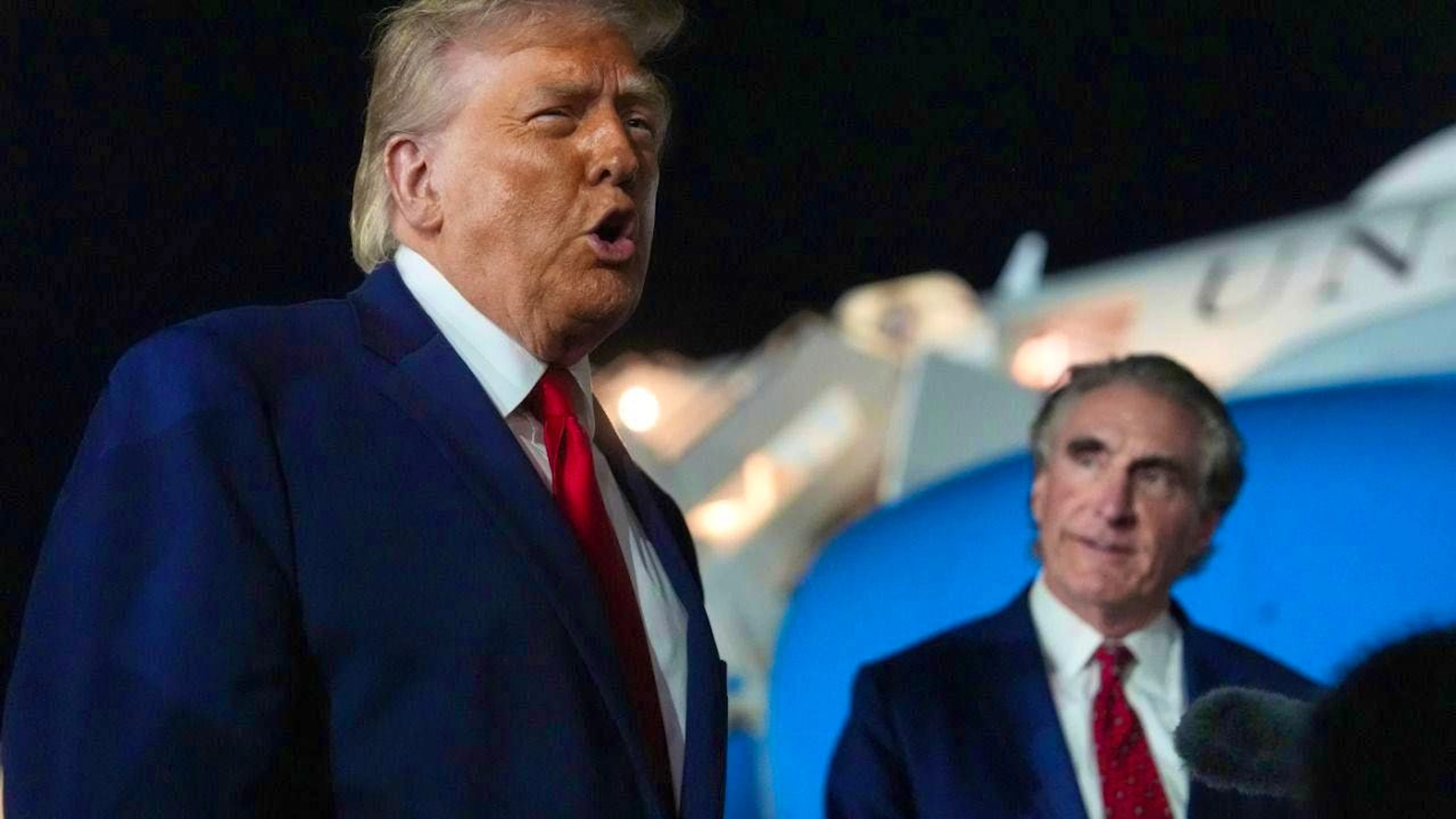 US President Donald Trump speaks to reporters before boarding Air Force One at John F. Kennedy International Airport as Interior Secretary Doug Burgum listens. Photo: Mark Schiefelbein/AP/dpa