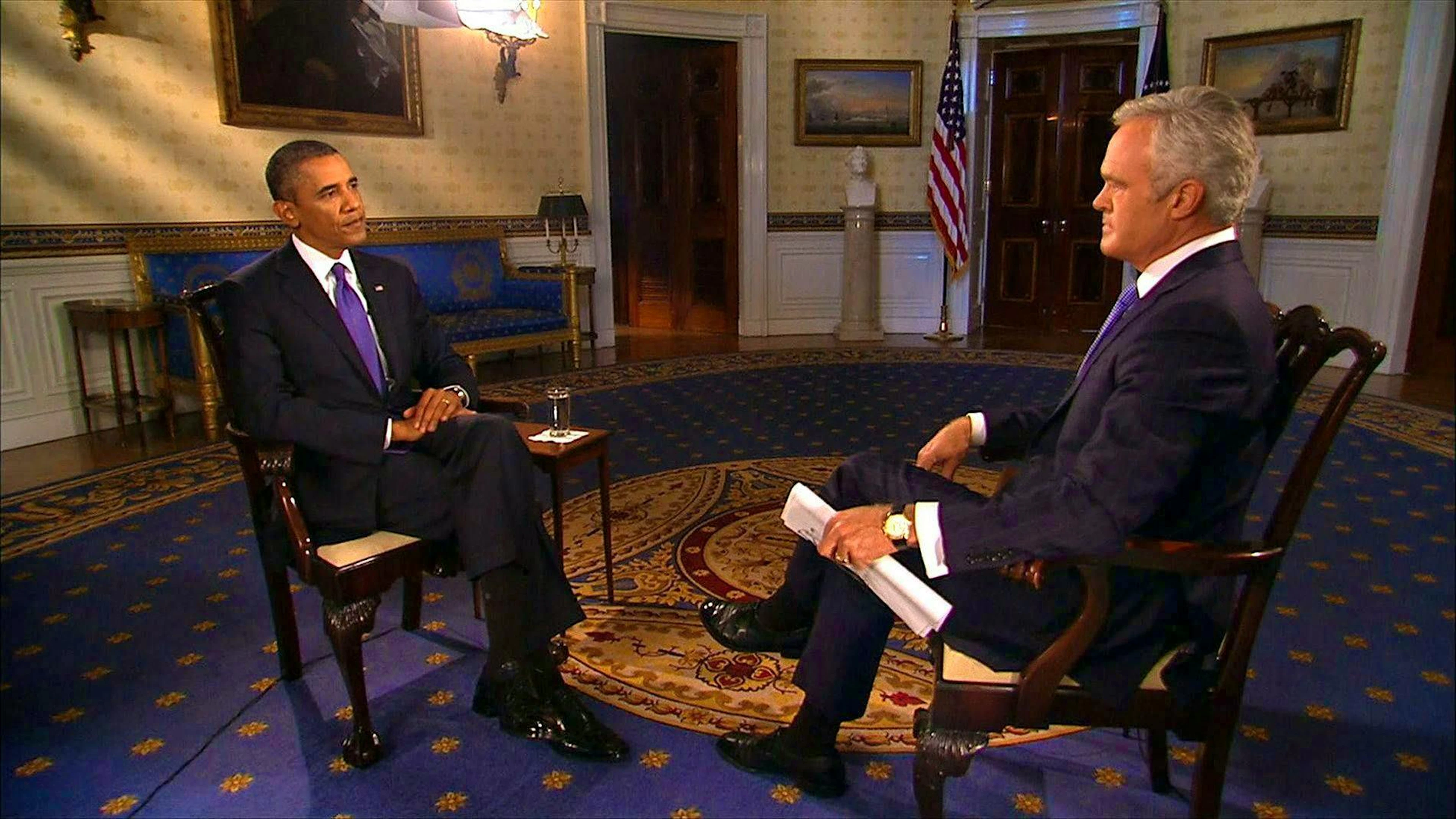Scott Pelley (right) interviews US President Barack Obama in September 2013.