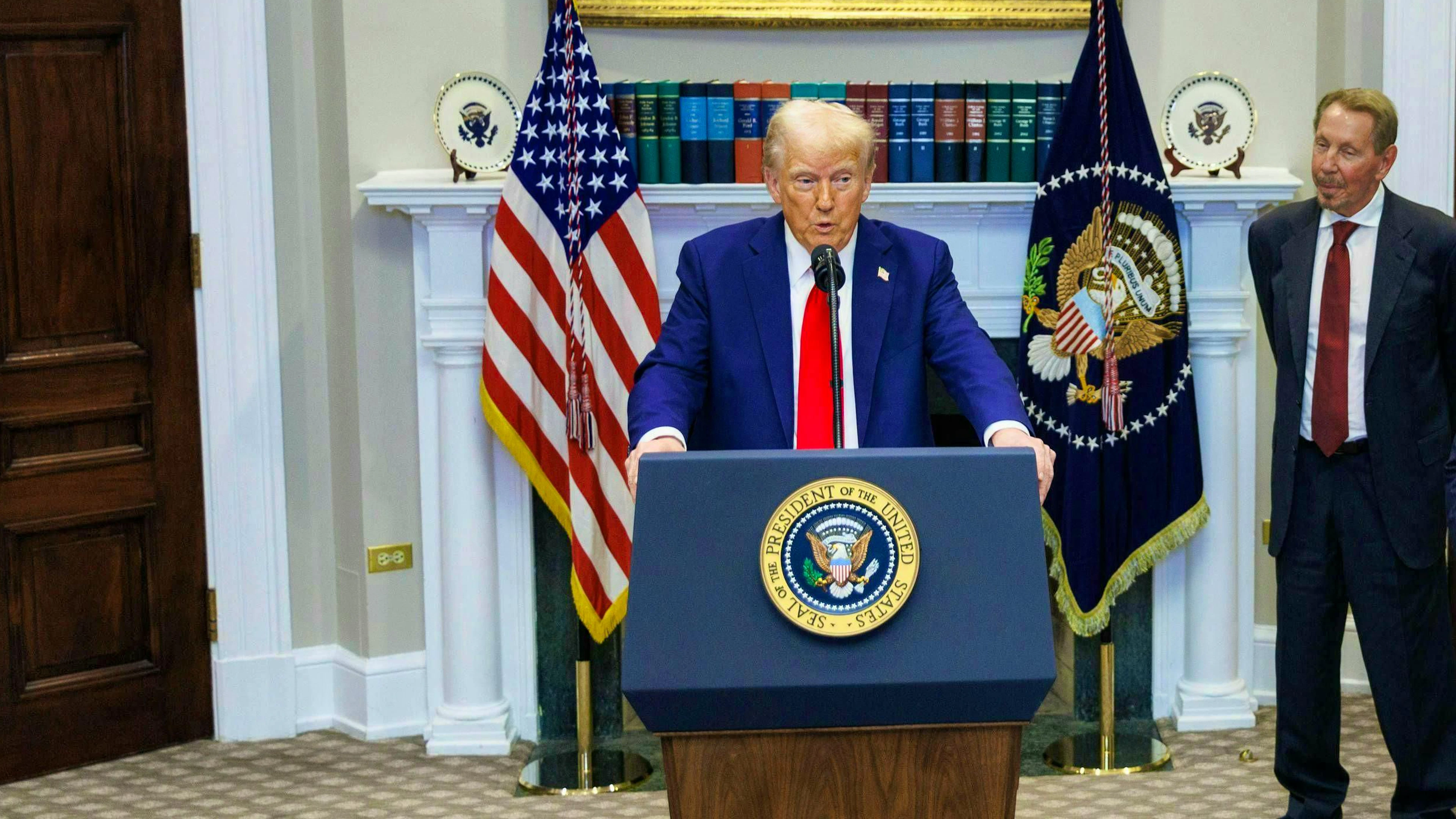 Donald Trump gives a speech in Washington on January 21, 2025 - Oracle founder Larry Ellison (right) listens.