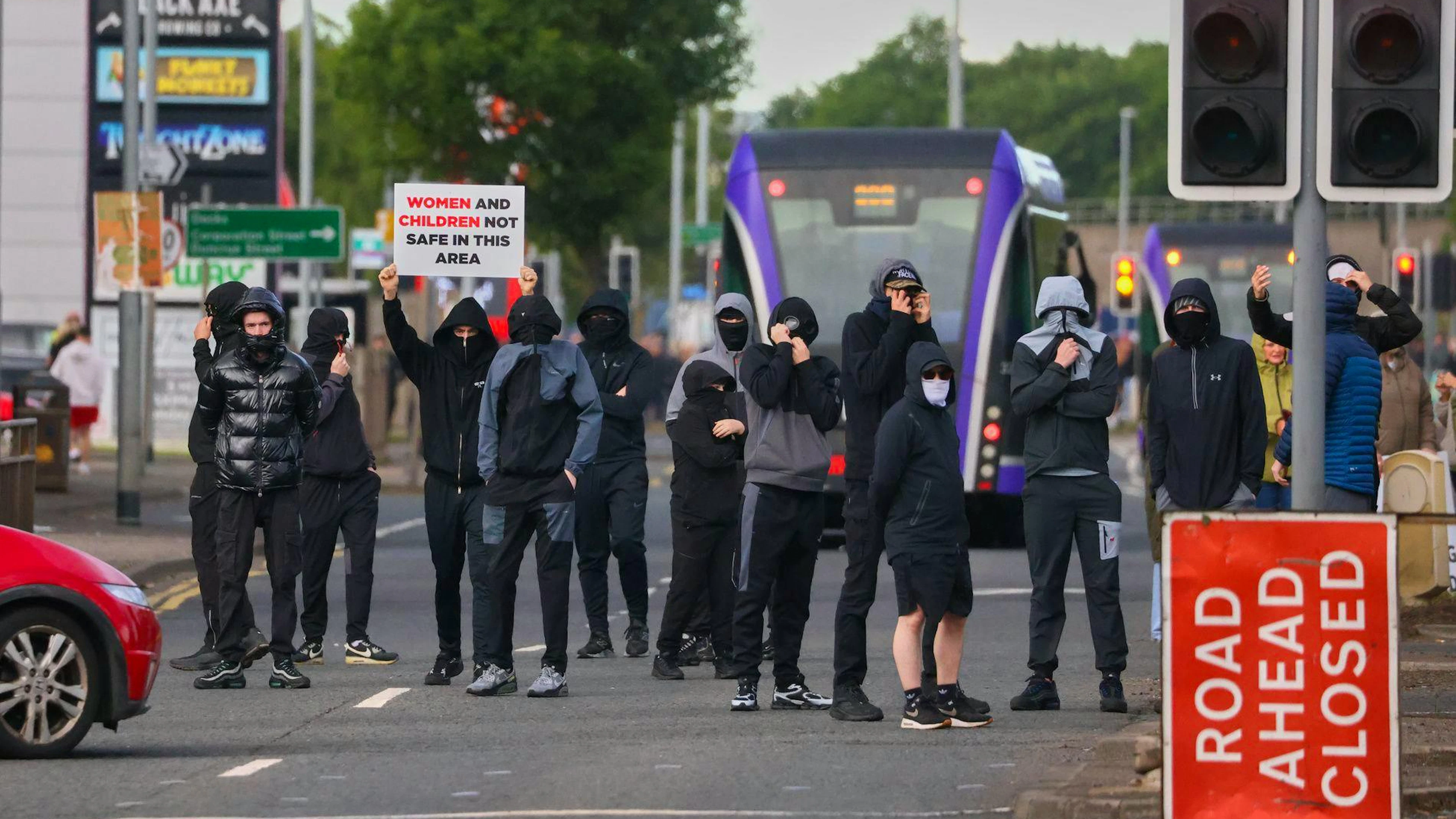 Vermummte Menschen versammeln sich am Dienstag in Belfast. Der Messerangriff ereignete sich am Montag.&nbsp;