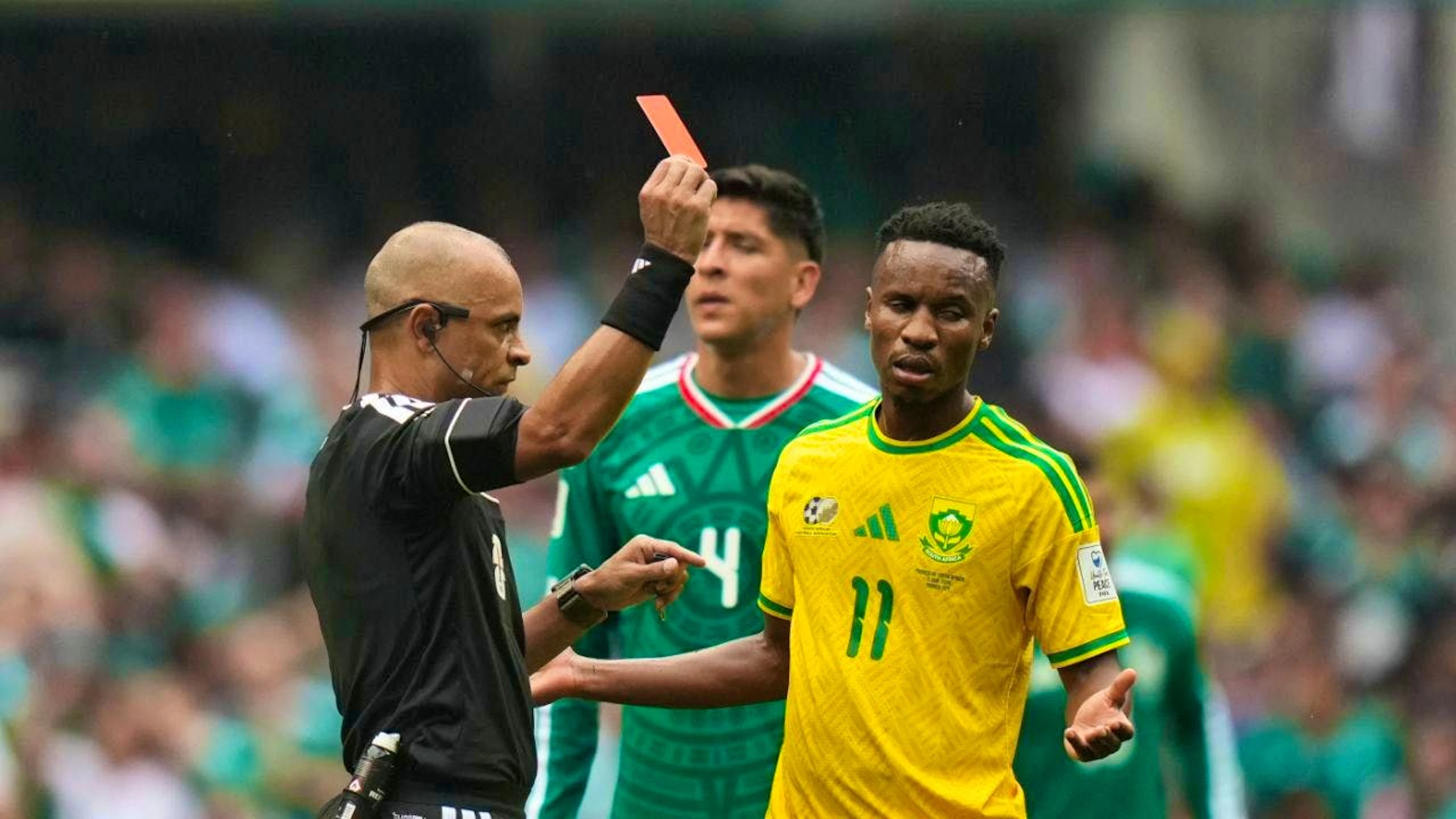 Referee Wilton Pereira Sampaio shows South Africa’s Themba Zwane a red card for violent conduct