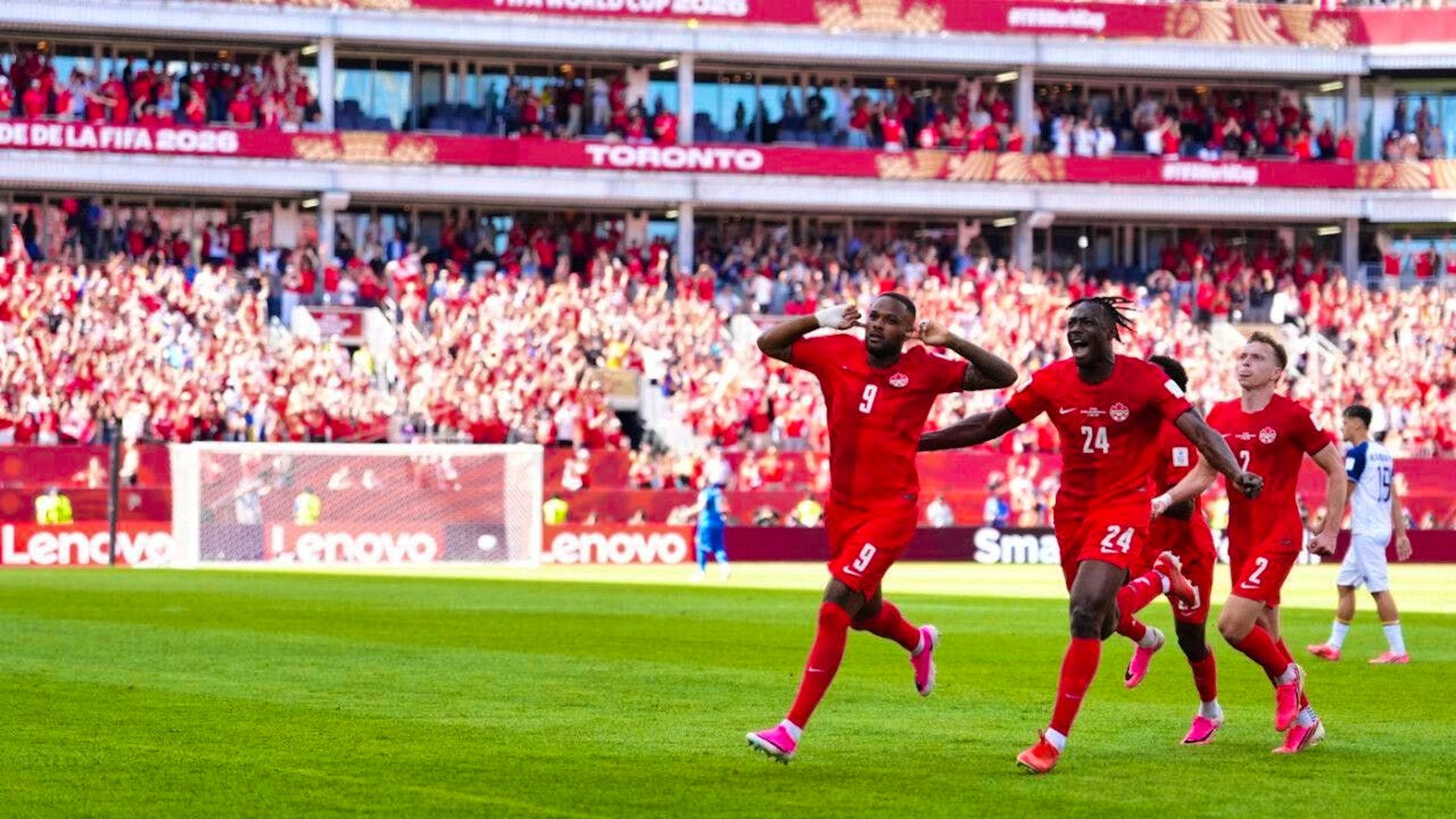 Substitute Cyle Larin (left) helps his country earn its first point in World Cup history in front of a home crowd in Toronto