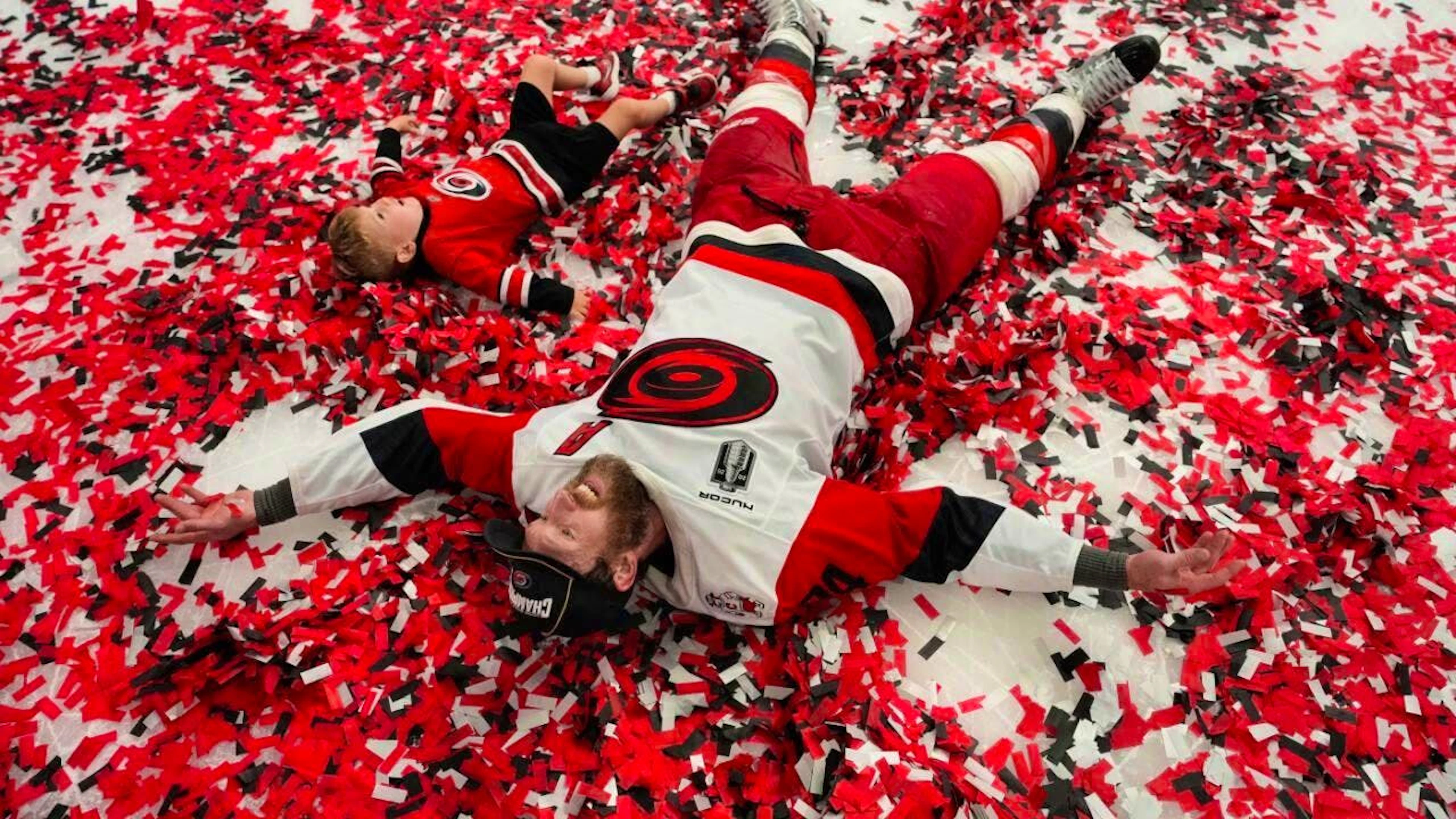 The Carolina Hurricanes in a shower of confetti in their team colors