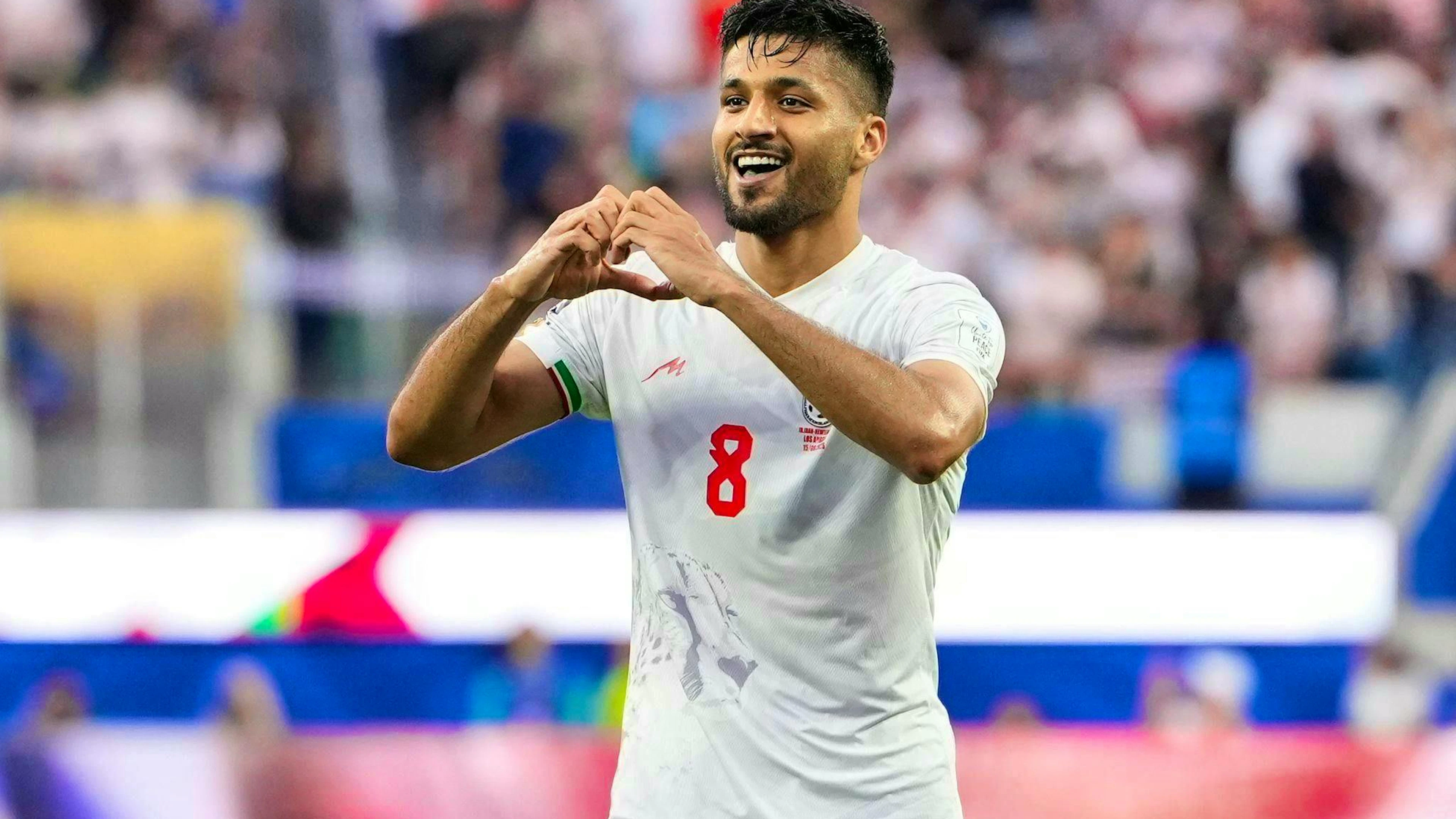 Iran's Mohammad Mohebbi celebrates his goal.