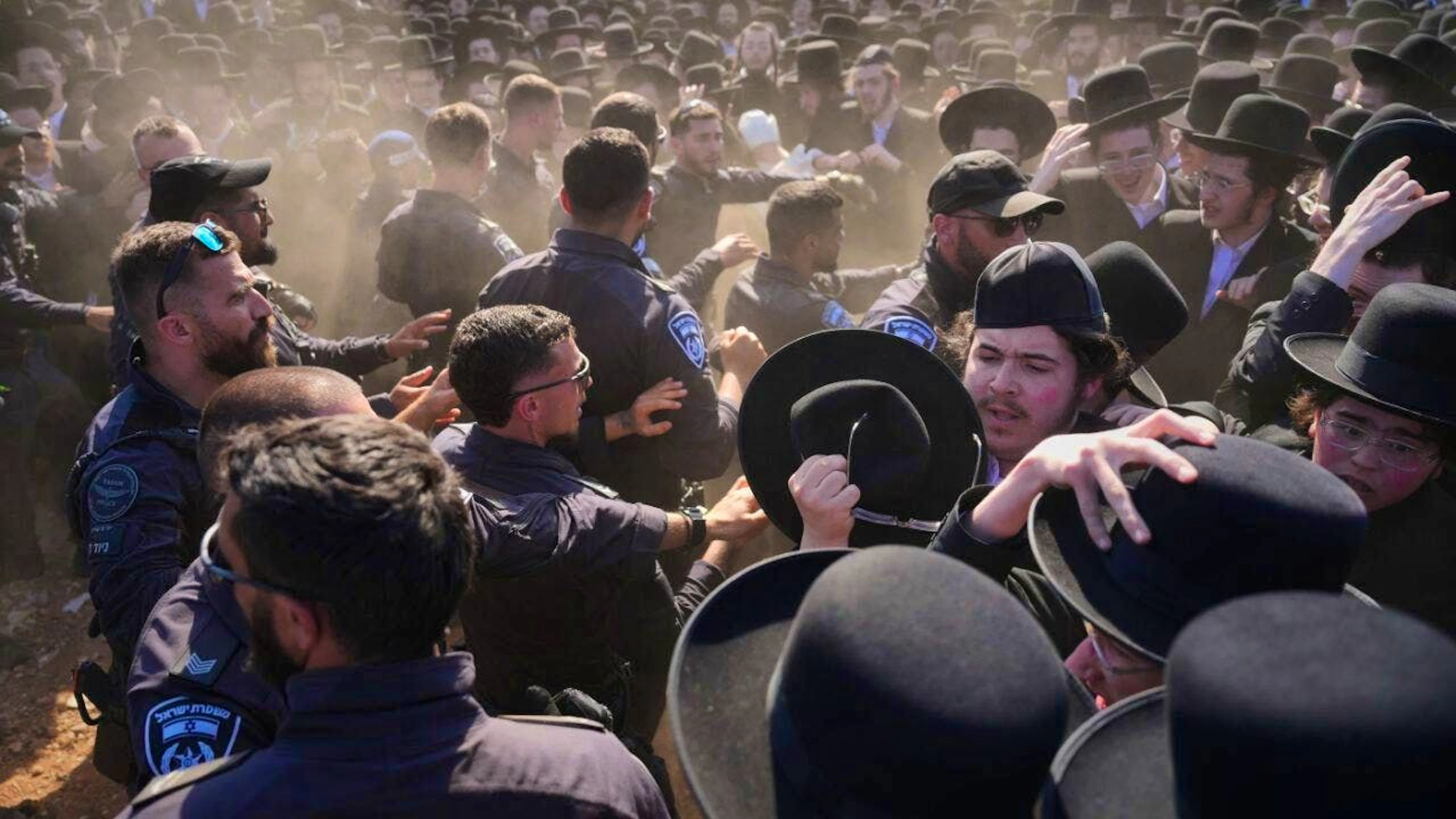 Ultra-Orthodox Jewish men clash with police during a demonstration against universal conscription outside a military prison near Kfar Yona, Israel, on Wednesday. The demonstrators are demanding the release of imprisoned conscientious objectors. Photo: Ariel Schalit/AP/dpa