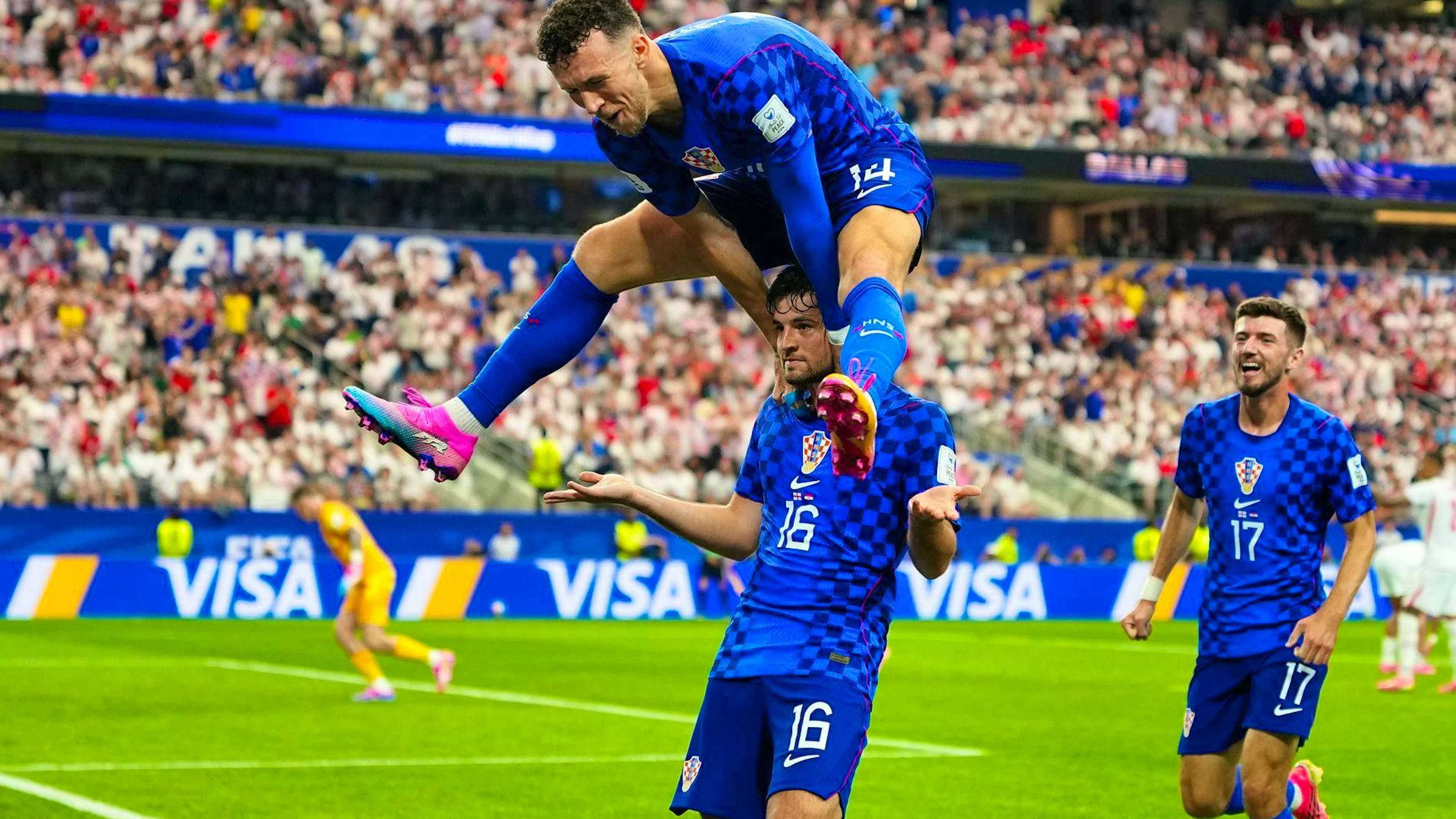 The goal celebration of the tournament: Ivan Perisic jumps over goal scorer Martin Baturina.