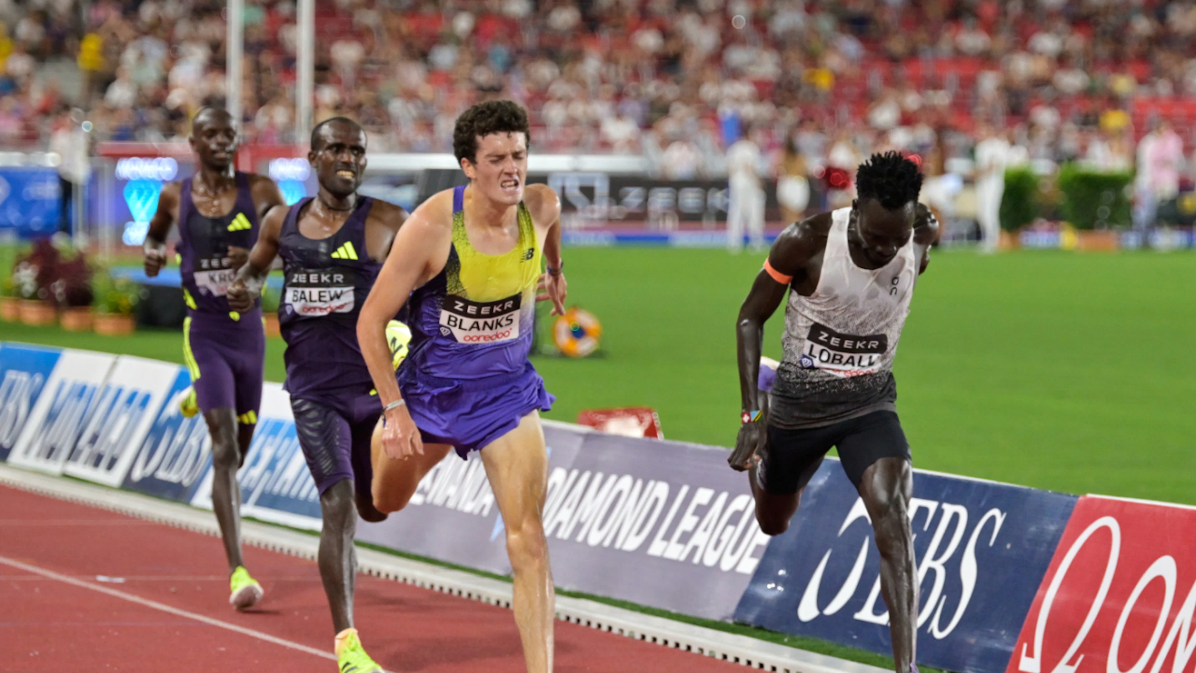 Dominic Lobalu (right) powers past American Graham Blanks to claim victory