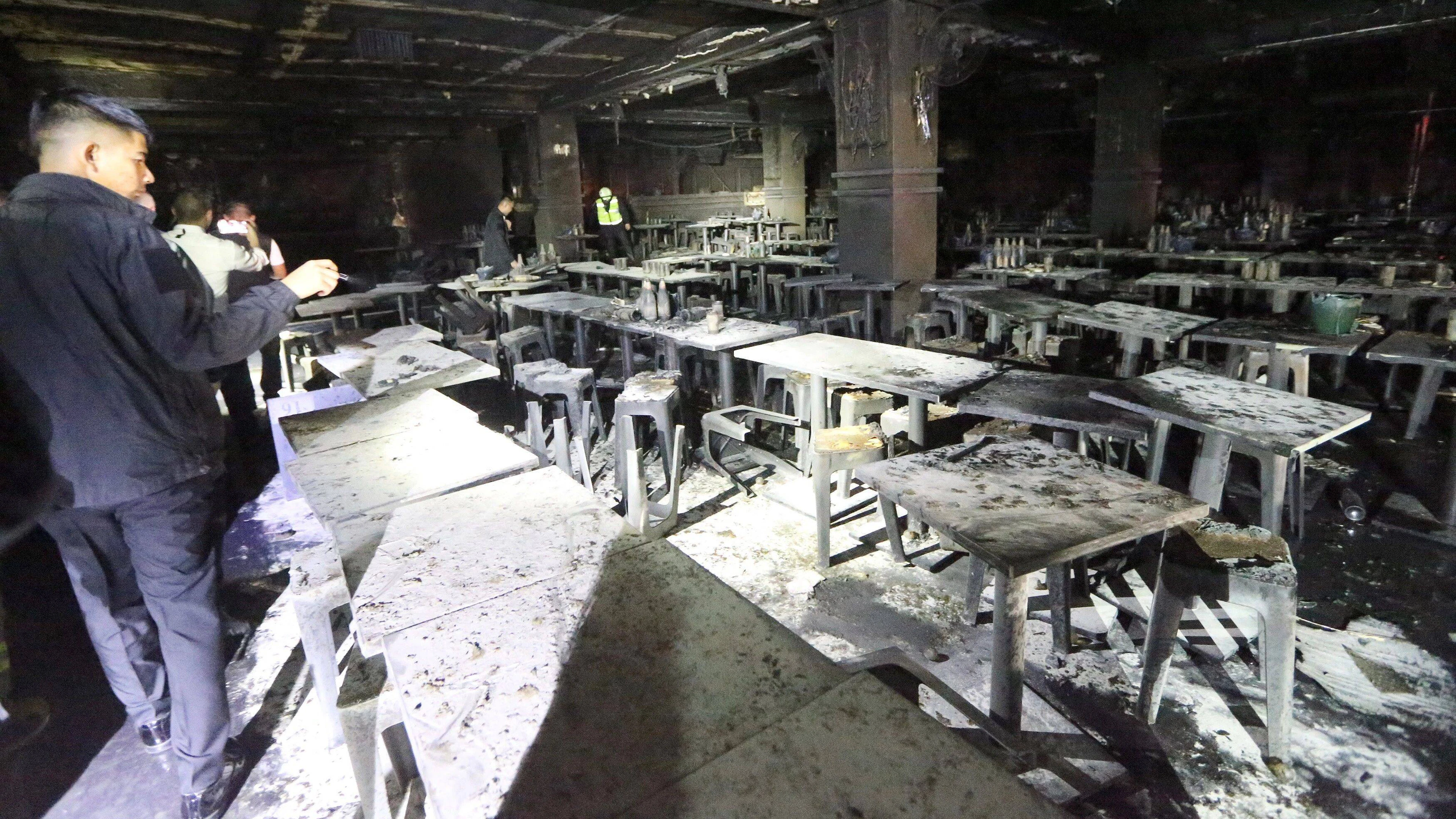 Rescue workers at the completely burned-out restaurant.