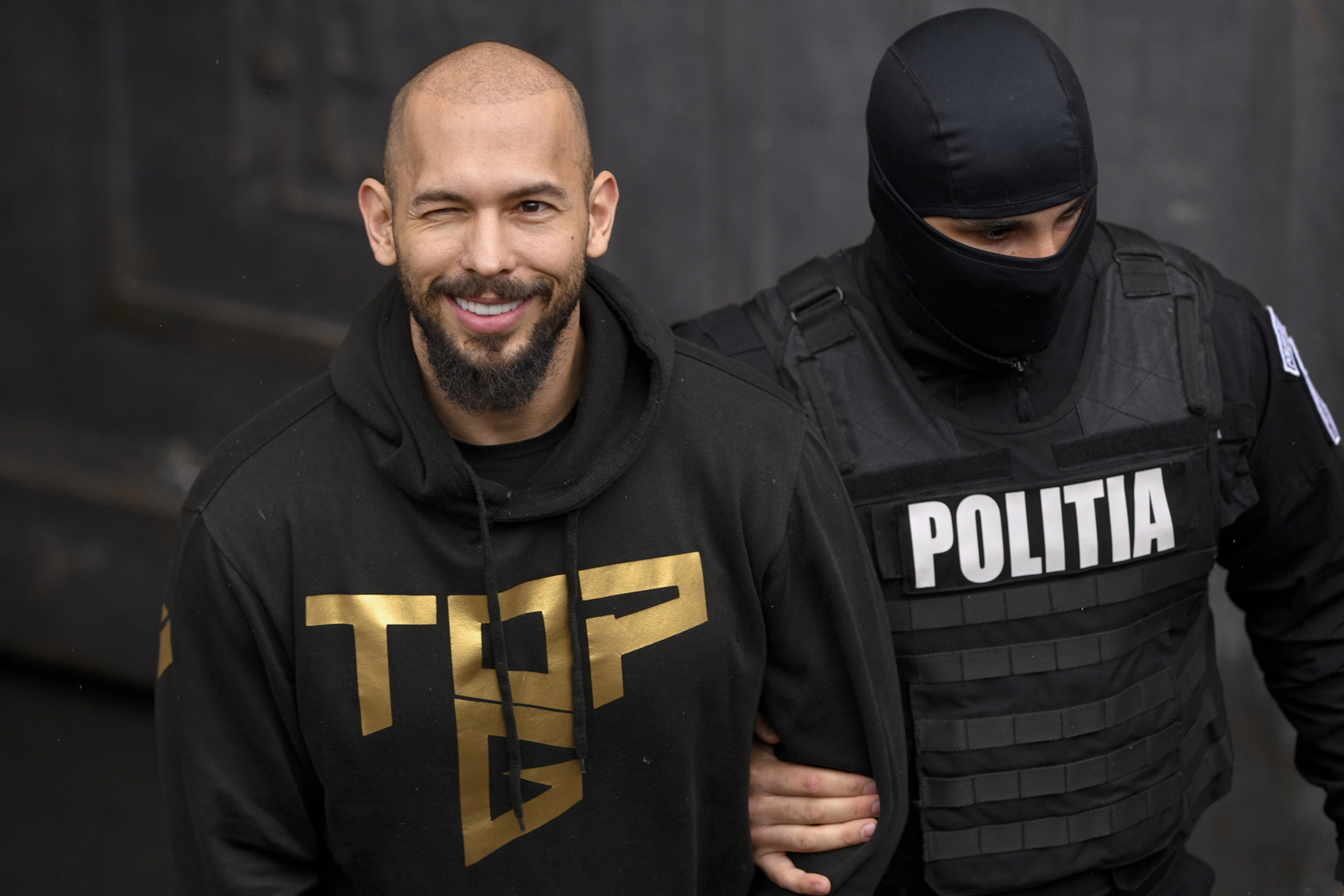 Andrew Tate as he was led out of the courthouse in handcuffs in Bucharest in March 2024.