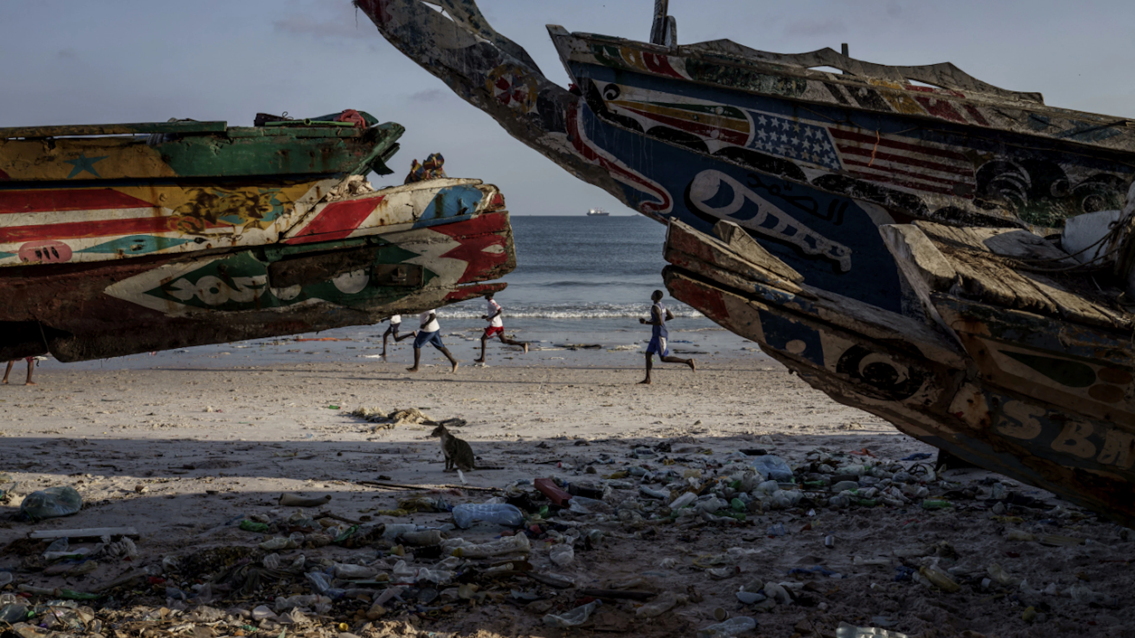 ARCHIVE – Teenagers play soccer on the beach in Thiaroye-Sur-Mer. Migrants from Senegal set out in simple fishing boats, known as pirogues, and spend several days battling strong winds and Atlantic currents. Photo: Annika Hammerschlag/AP/dpa