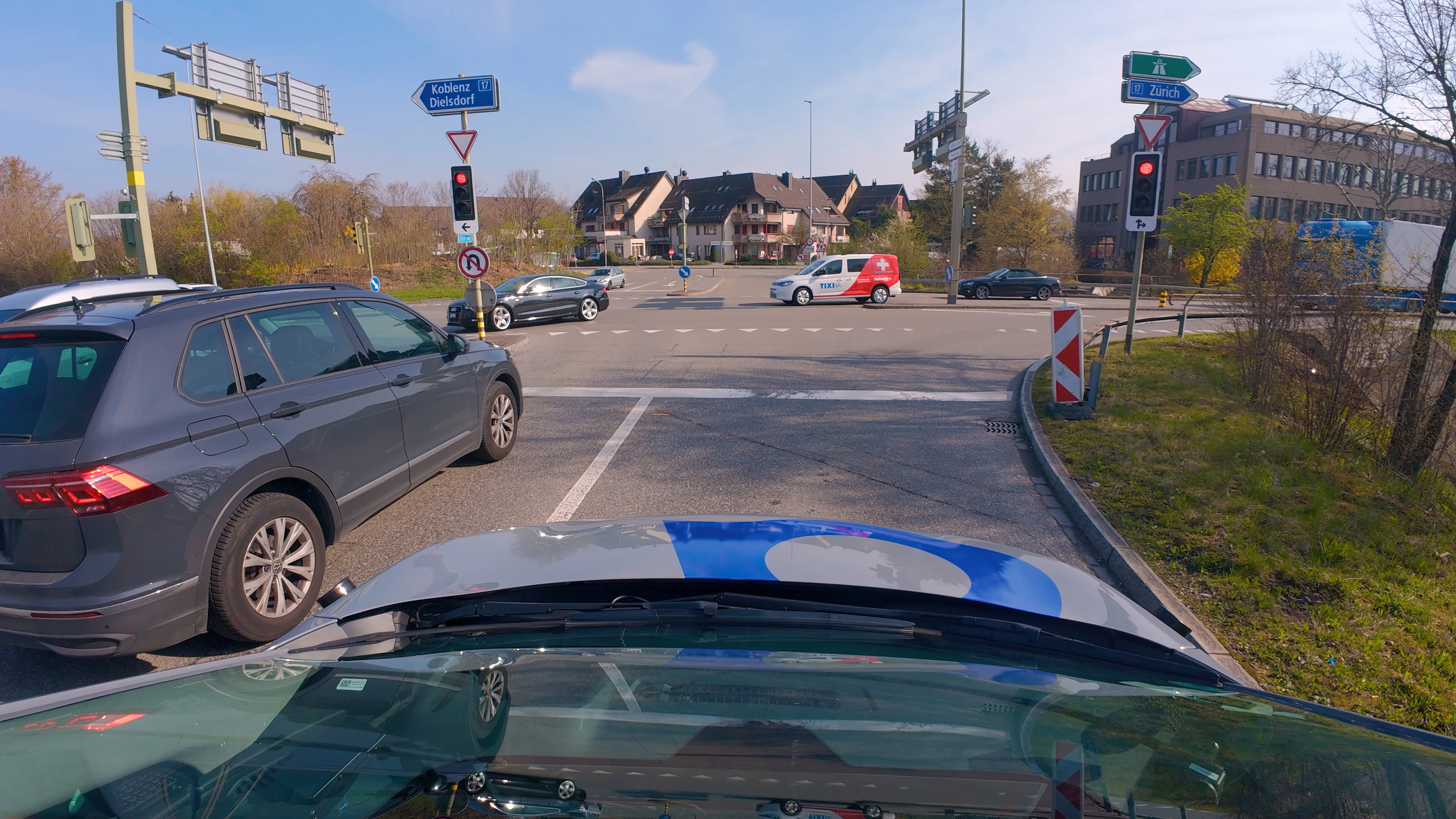 The self-driving car is programmed for safety and therefore stops at the traffic light, keeping a very safe distance.