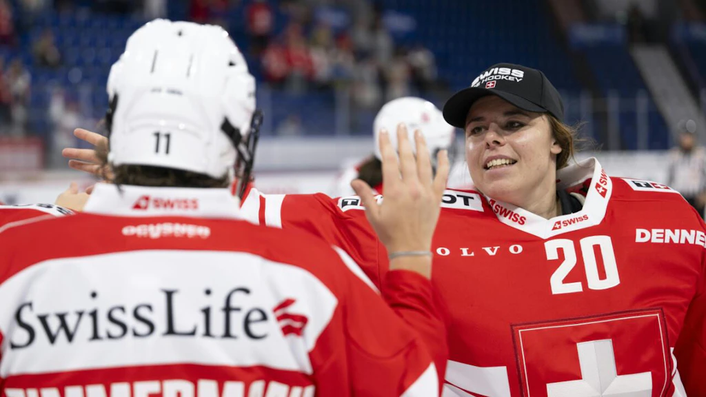 The Swiss women's national ice hockey team celebrating their victory on ice