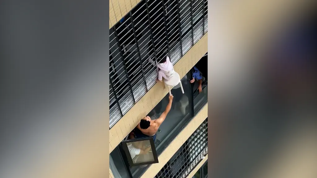 Three-year-old dangles from the 12th floor of a high-rise building